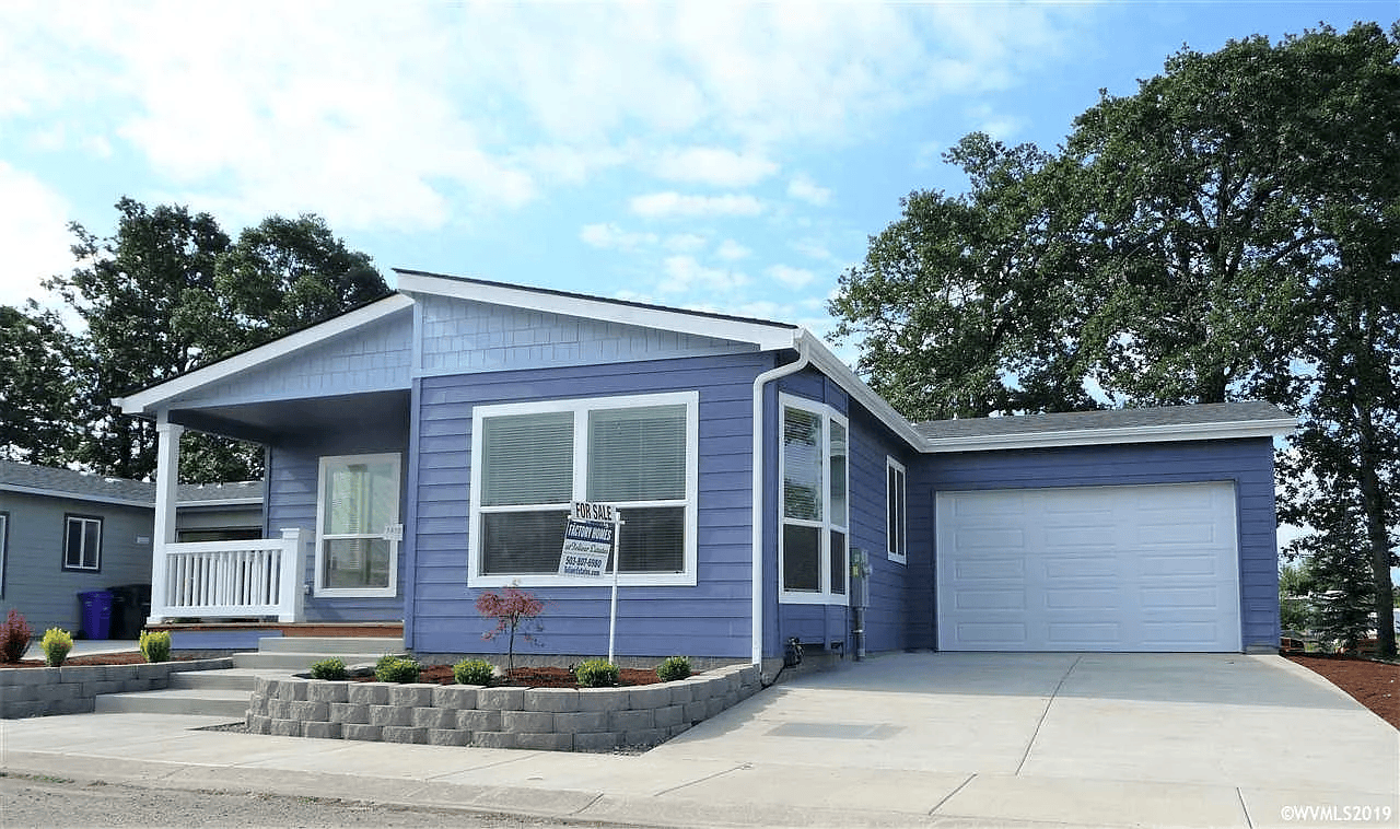 Blue single-story house with white trim and a garage, with a 