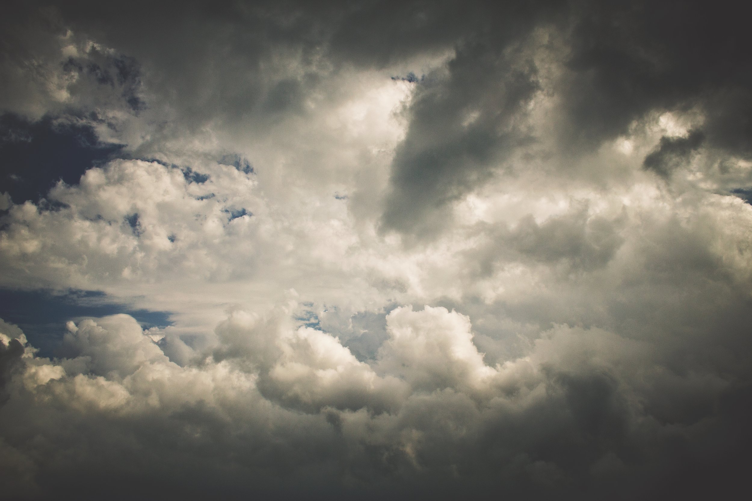 Cloudy overcast sky with dark gray clouds and some lighter patches.