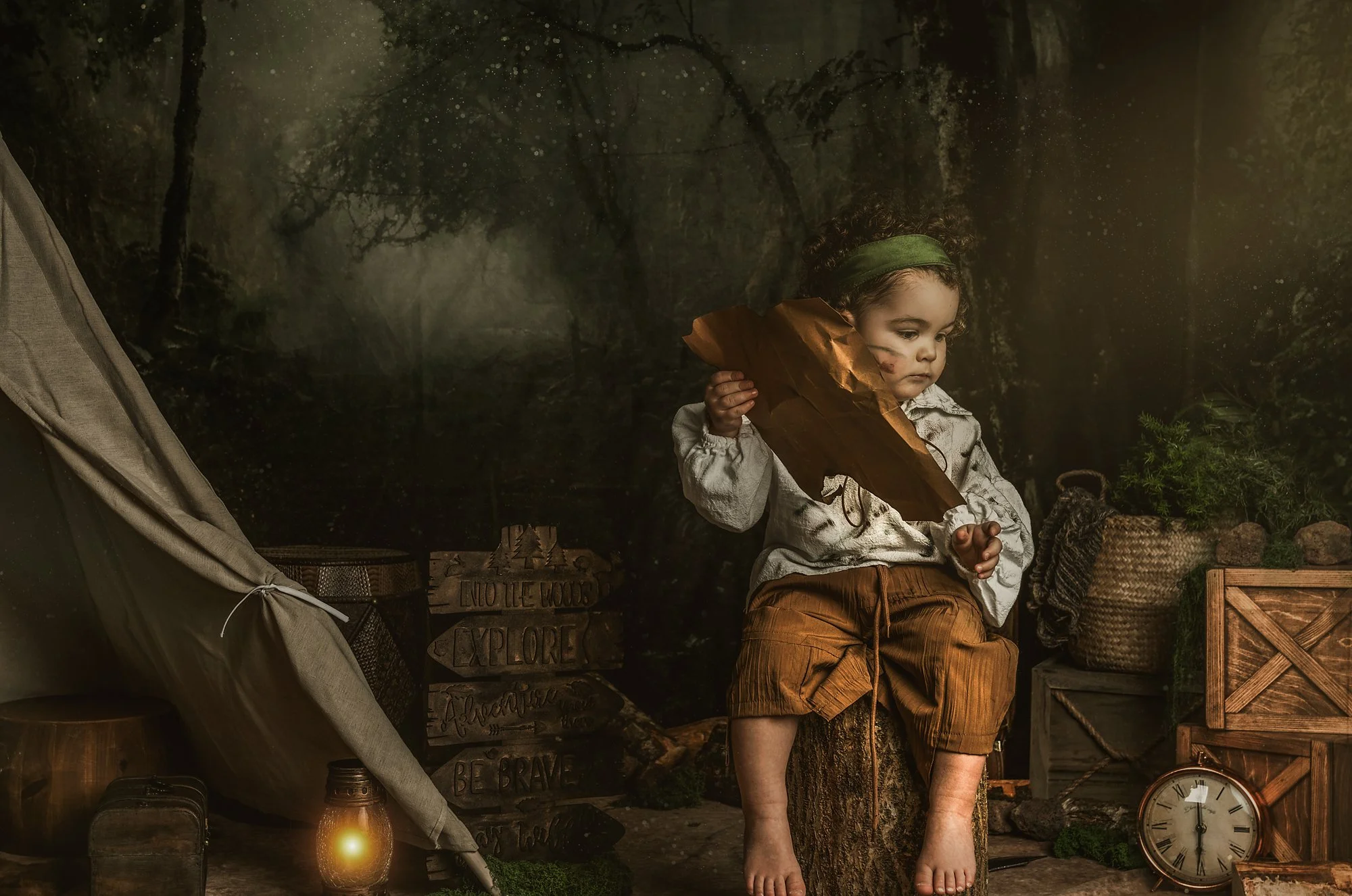 A young boy looking into the distance dressed as a lost boy