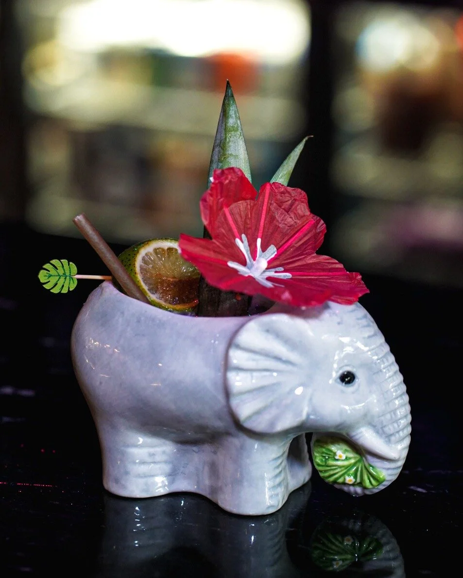 Crafted to delight both the eye and the palate. 🐘🌺 The Pink Elephant pairs gin and citrus with the soft sweetness of orgeat, pineapple, and cr&egrave;me de violette for a sip of elegance.