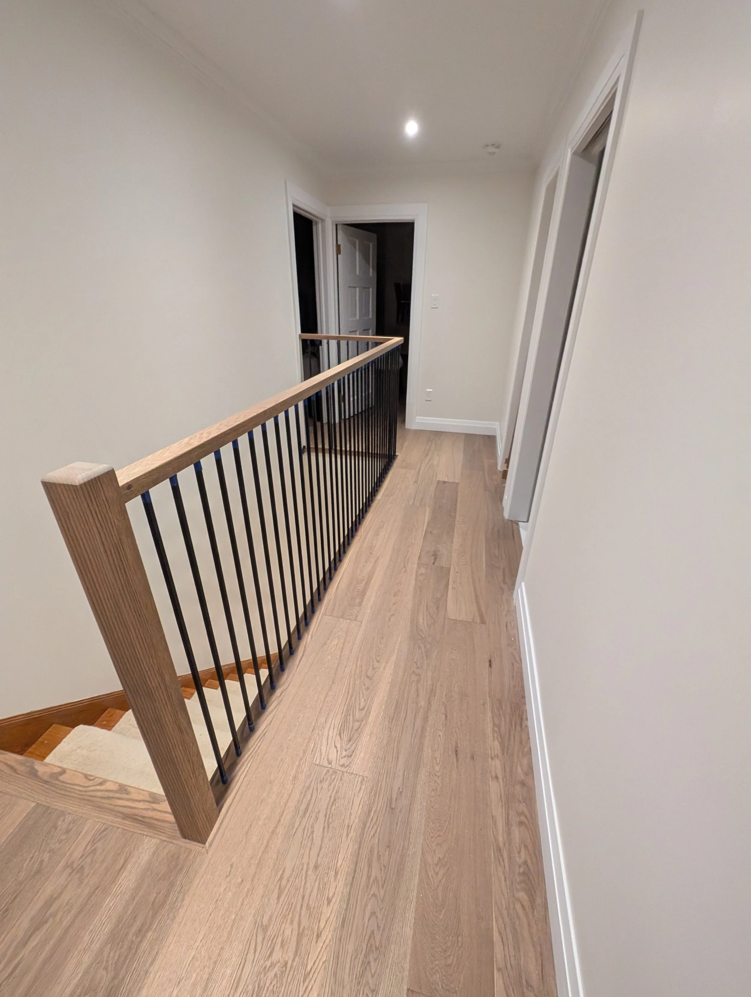 Engineered hardwood flooring with a custom oak handrailing