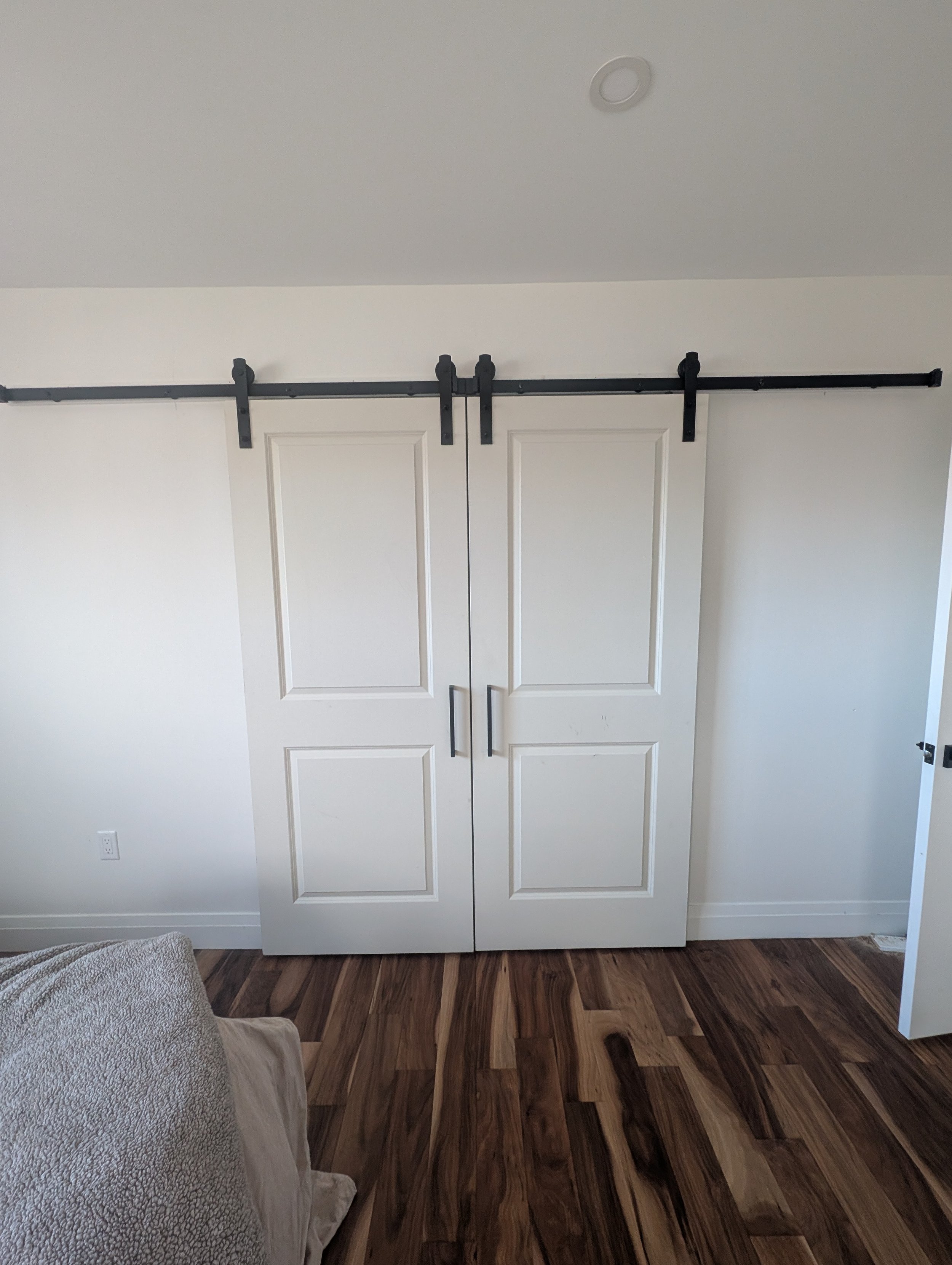 Double barn door sliders to conceal a walk-in closet