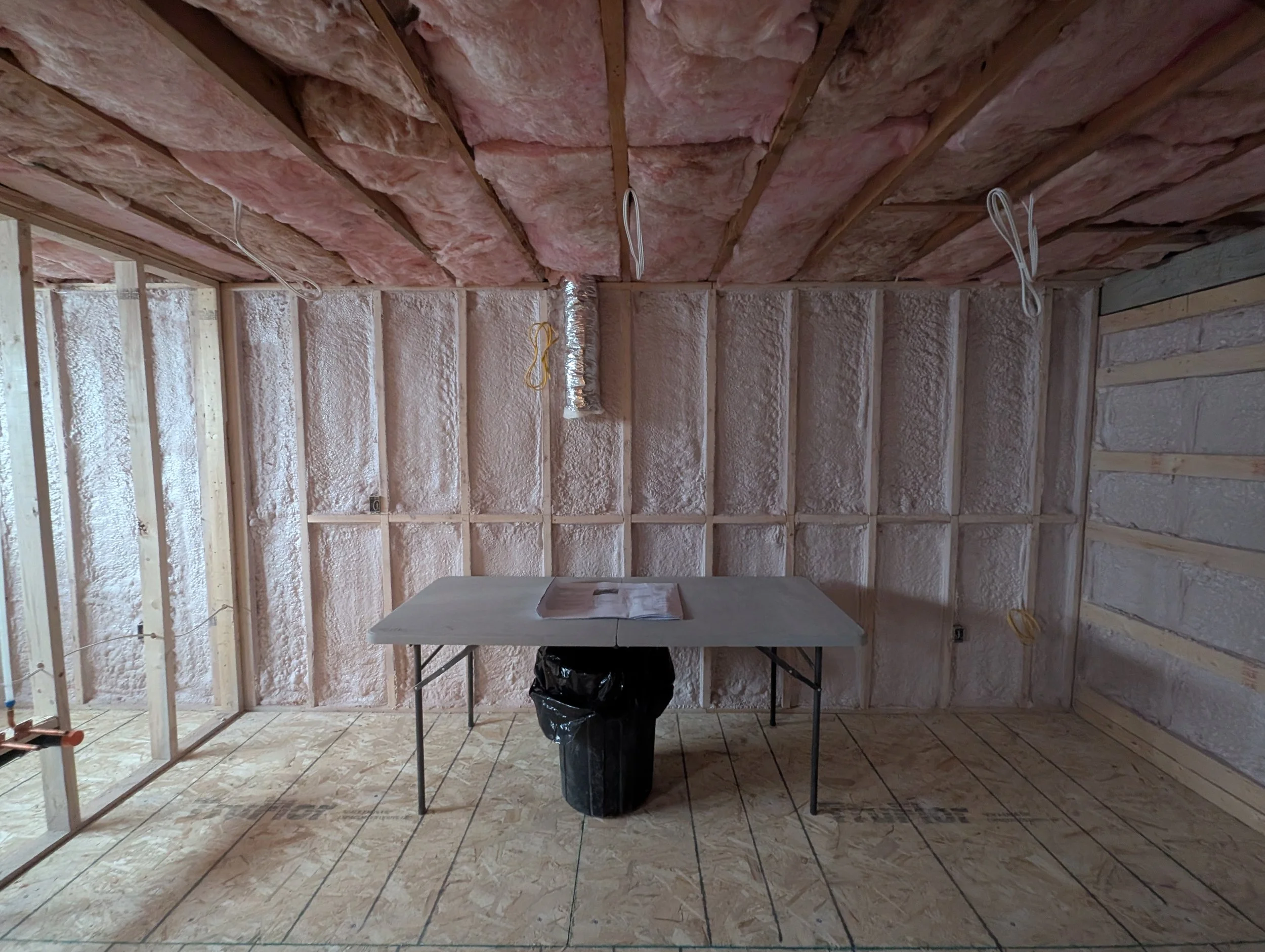 Unfinished basement made comfortable with spray foam and fiberglass insulation