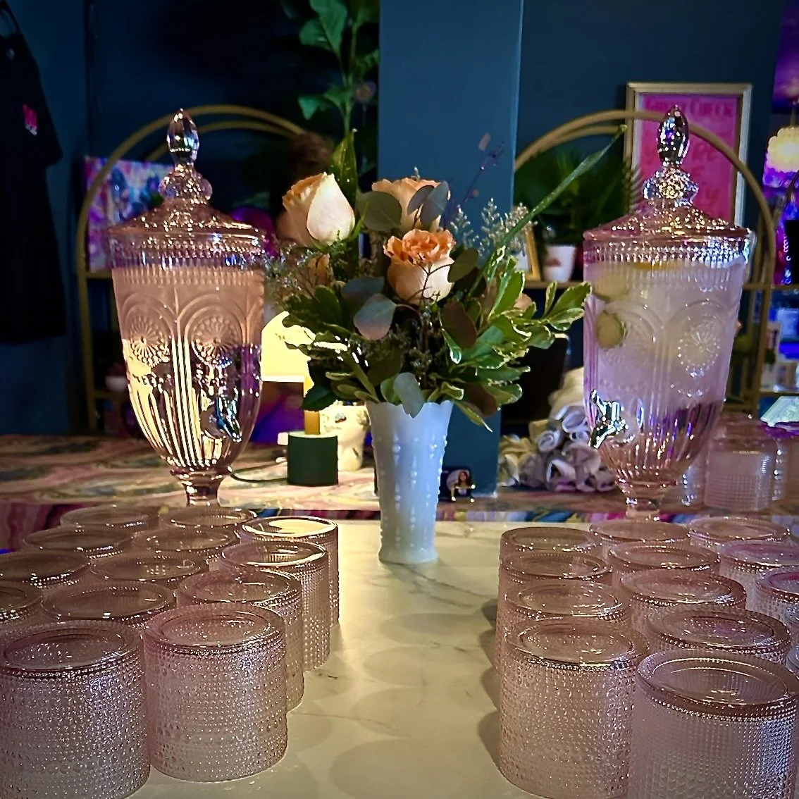 Table with pink glassware, ornate jars, and flower bouquet Baby shower, wedding shower, wedding, celebration, private dining, private events, birthdays, custom menu. restaurant rentals.
