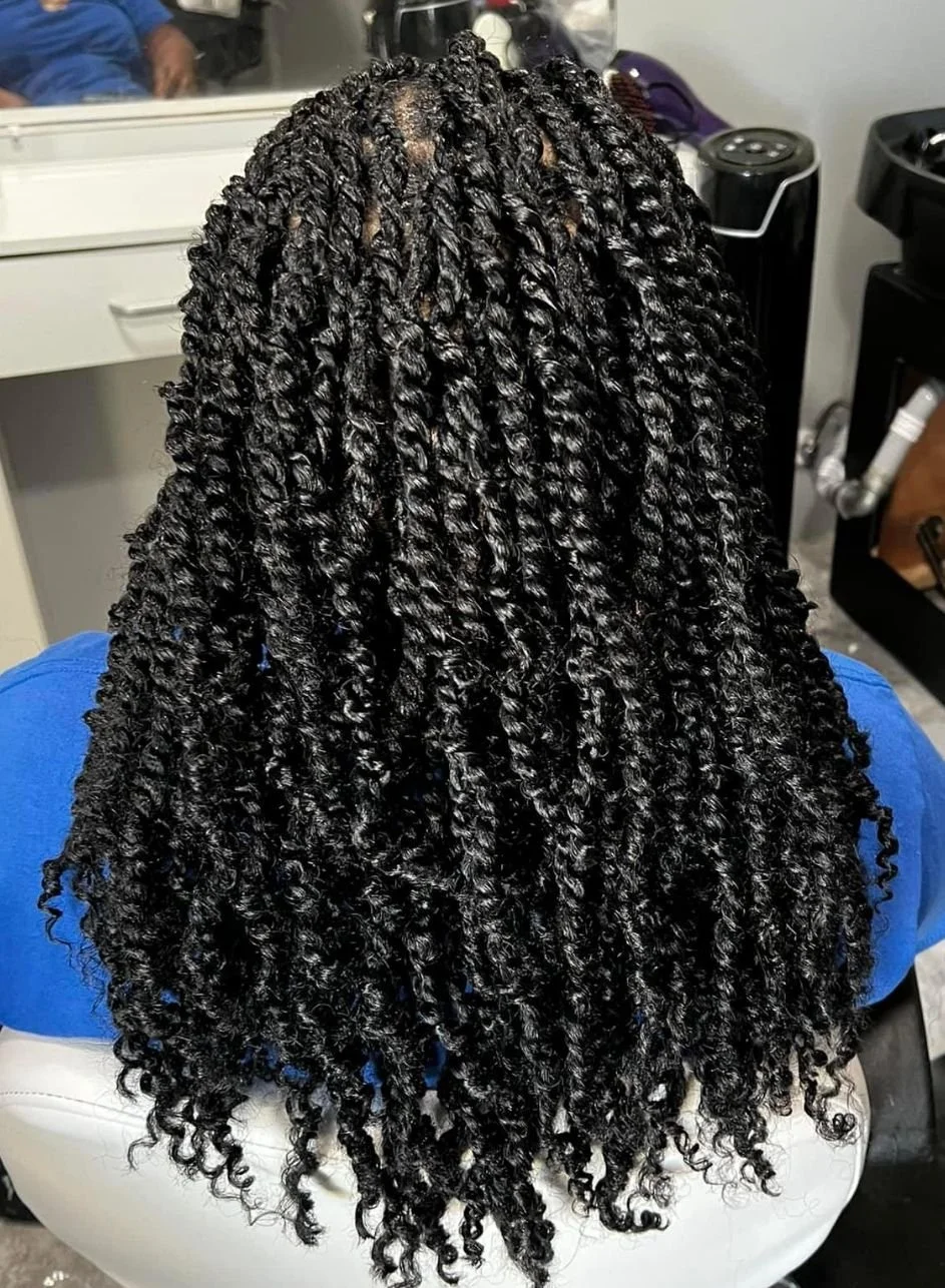 Close-up of a person's hair styled in long, tight, defined twists with a glossy finish.