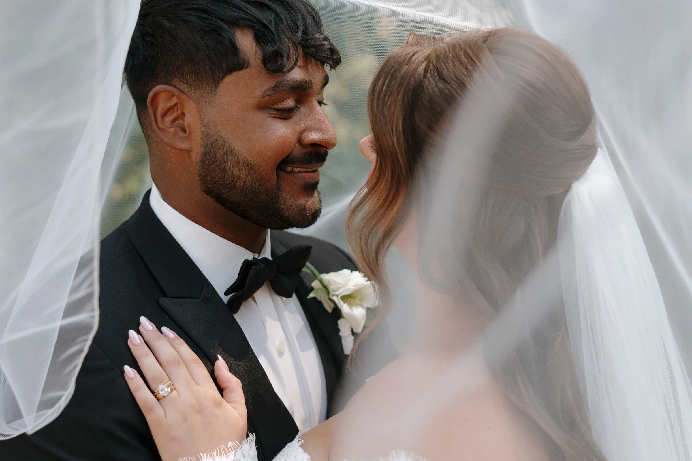 Couple_on_Wedding_Day_with_Brides_Veil_Surrounding_Them