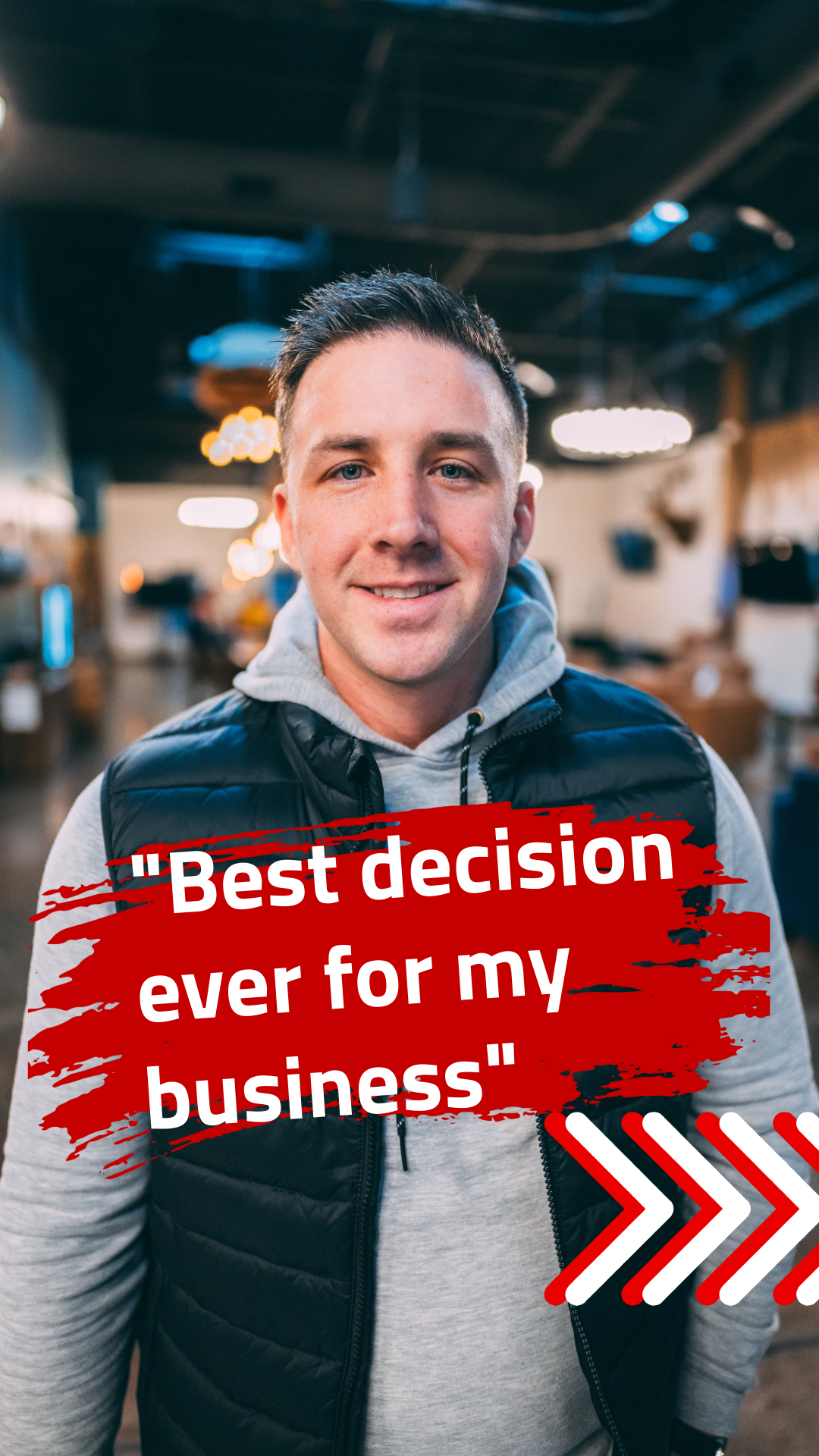 A young man smiling for a photo indoors with a quote overlayed on the image that says 'Best decision ever for my business'.