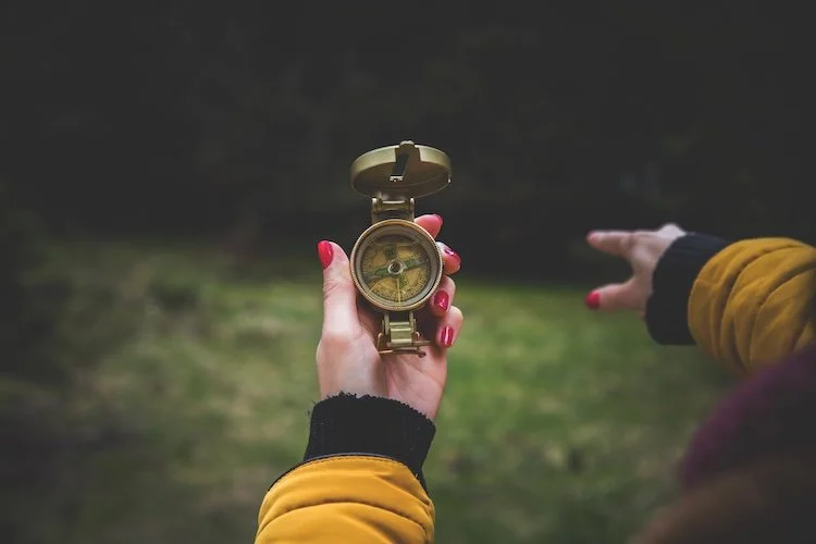 Woman holding compass pointing the way forward. Gentle Joy Sensitive Women's Leadership Collective with Lori Cangilla from Singularly Sensitive