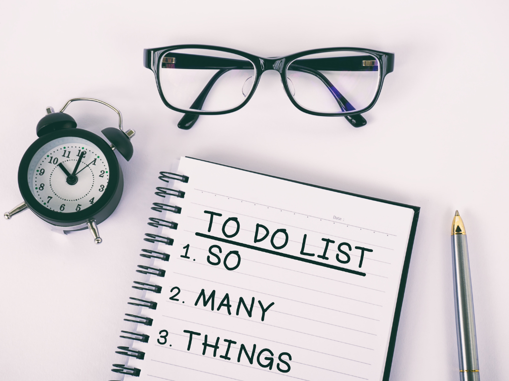Woman checking off items in a planner, representing managing perfectionism and productivity