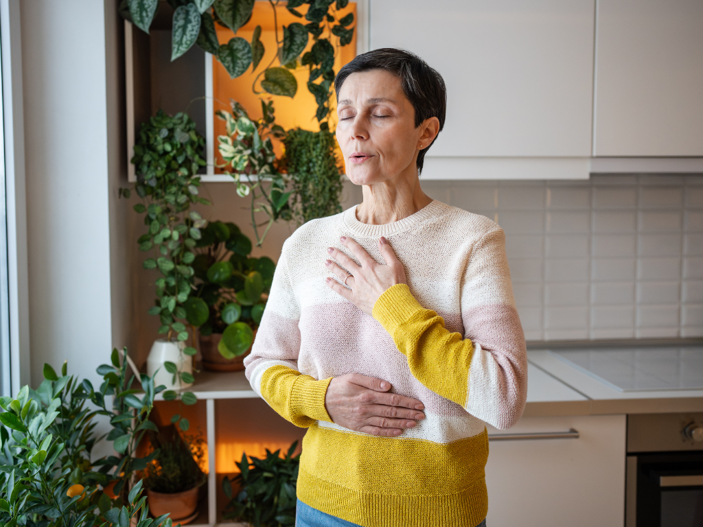 Woman pausing to regulate her breathing during a stressful financial task