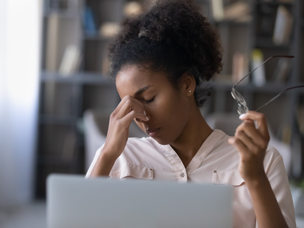 High-achieving woman experiencing burnout and emotional exhaustion while sitting alone after work