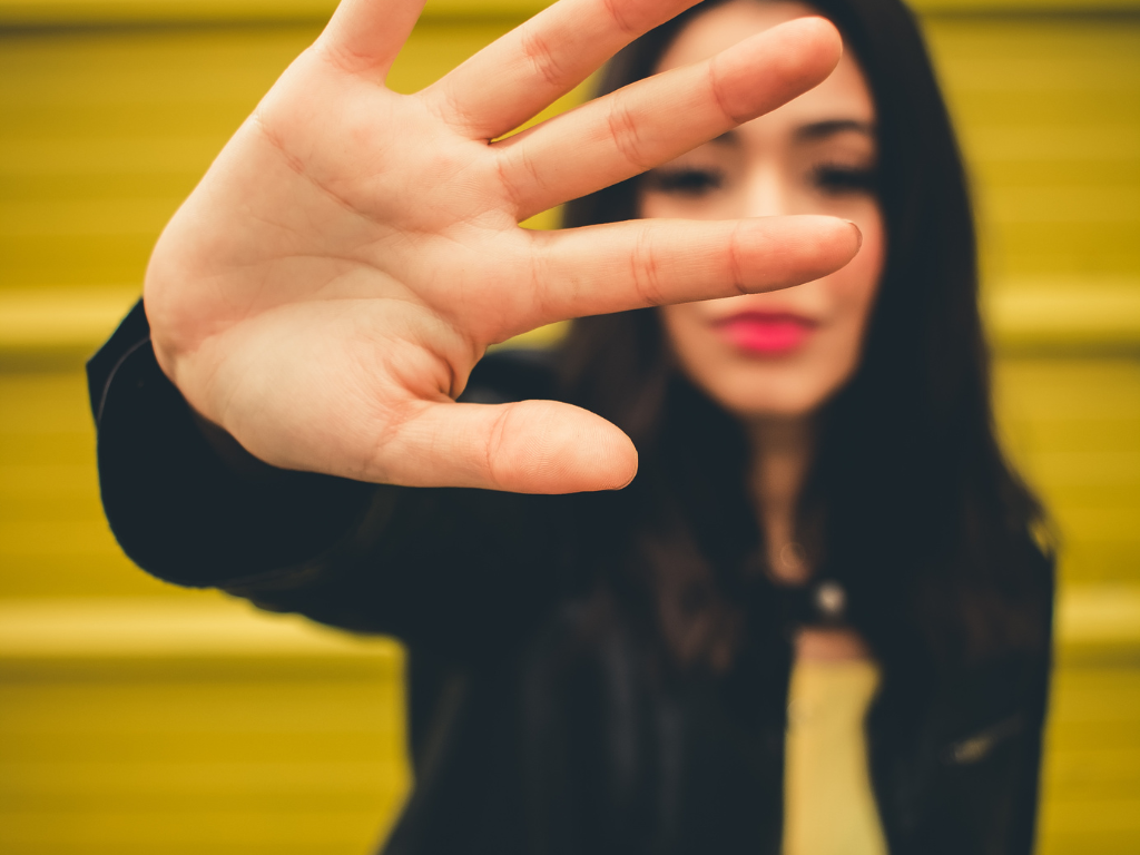 Setting boundaries to overcome people-pleasing behaviors and prioritize self-care.