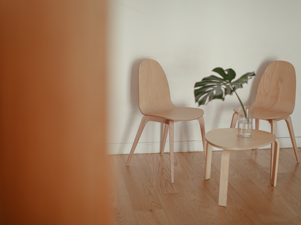 Two empty chairs facing each other in a quiet counseling office