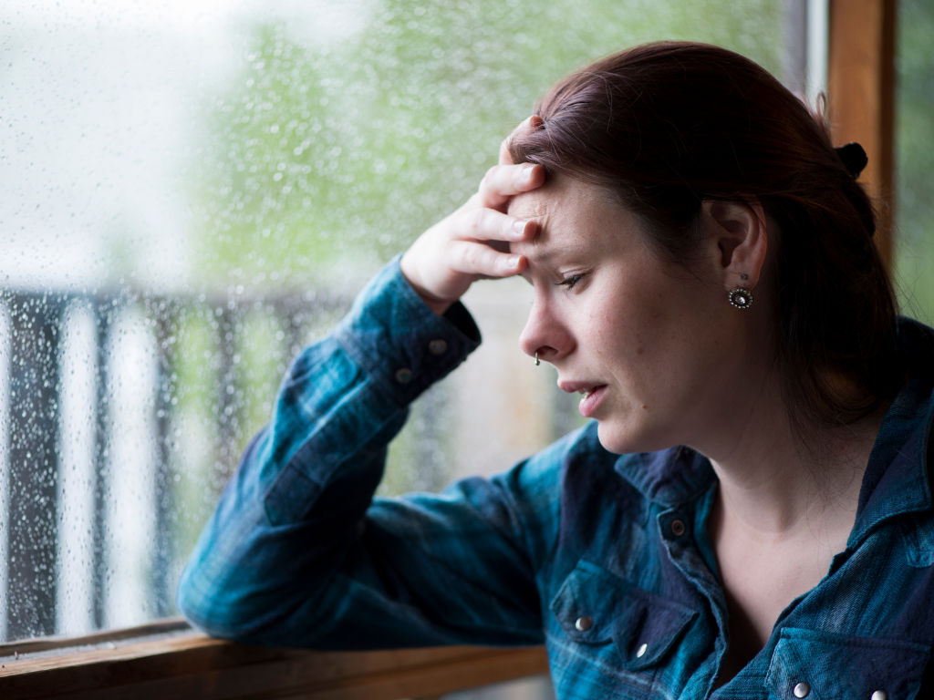 Emotionally overwhelmed woman struggling with anxiety, perfectionism, and burnout