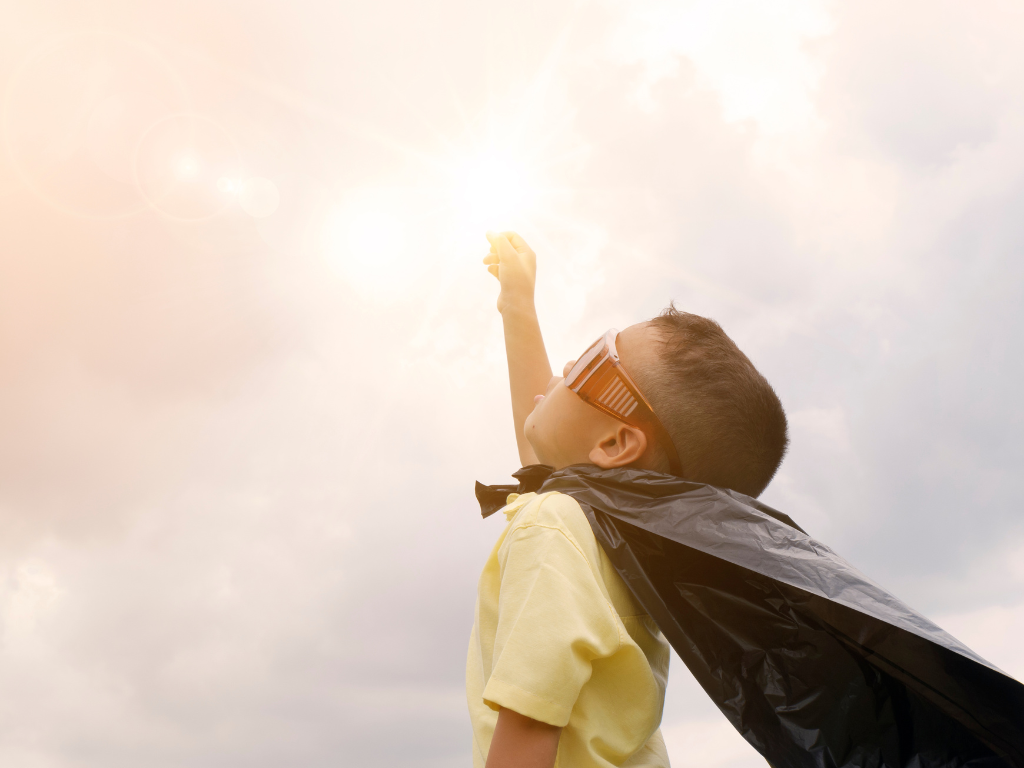 Happy child jumping in puddles showing resilience and confidence after overcoming anxiety.