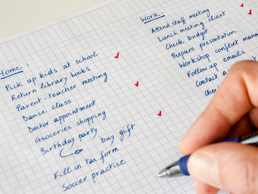 Open planner and unfinished to-do list beside a bed at night