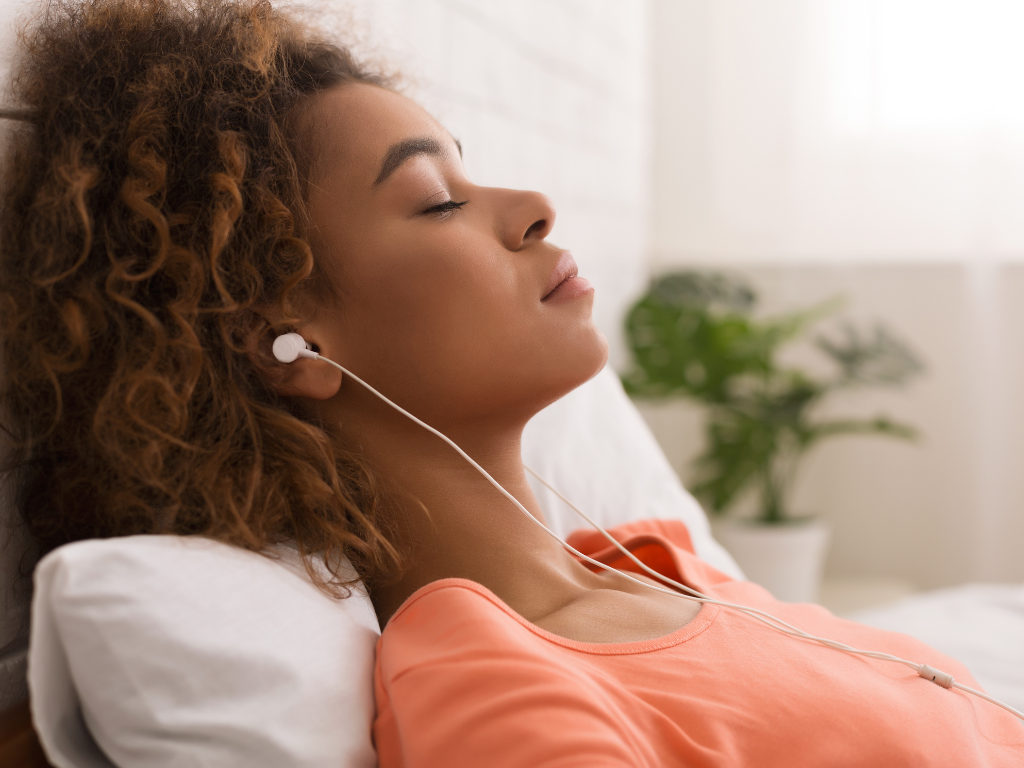 Woman relaxing outdoors with a calm expression, symbolizing recovery from perfectionism, burnout, and anxiety.
