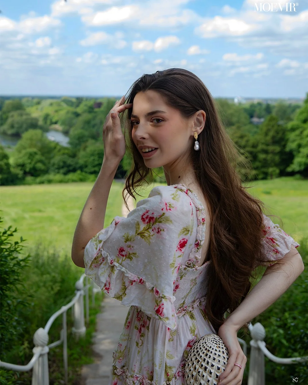 Young woman with beautiful natural makeup in a white floral dress in a magazine cover