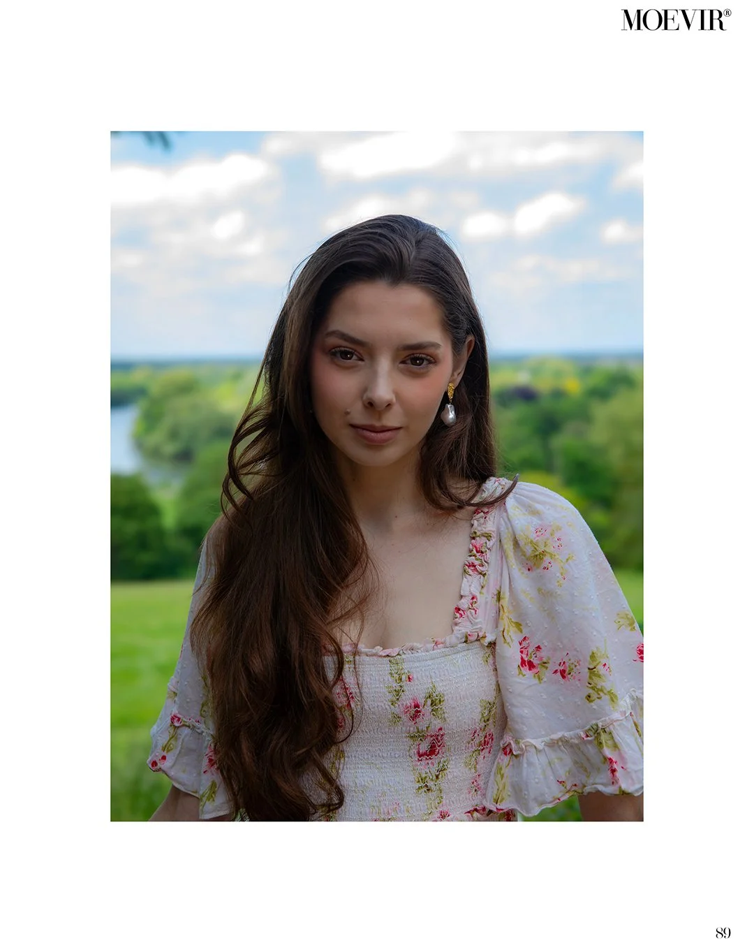 Young woman with beautiful natural makeup in a white floral dress in a magazine cover
