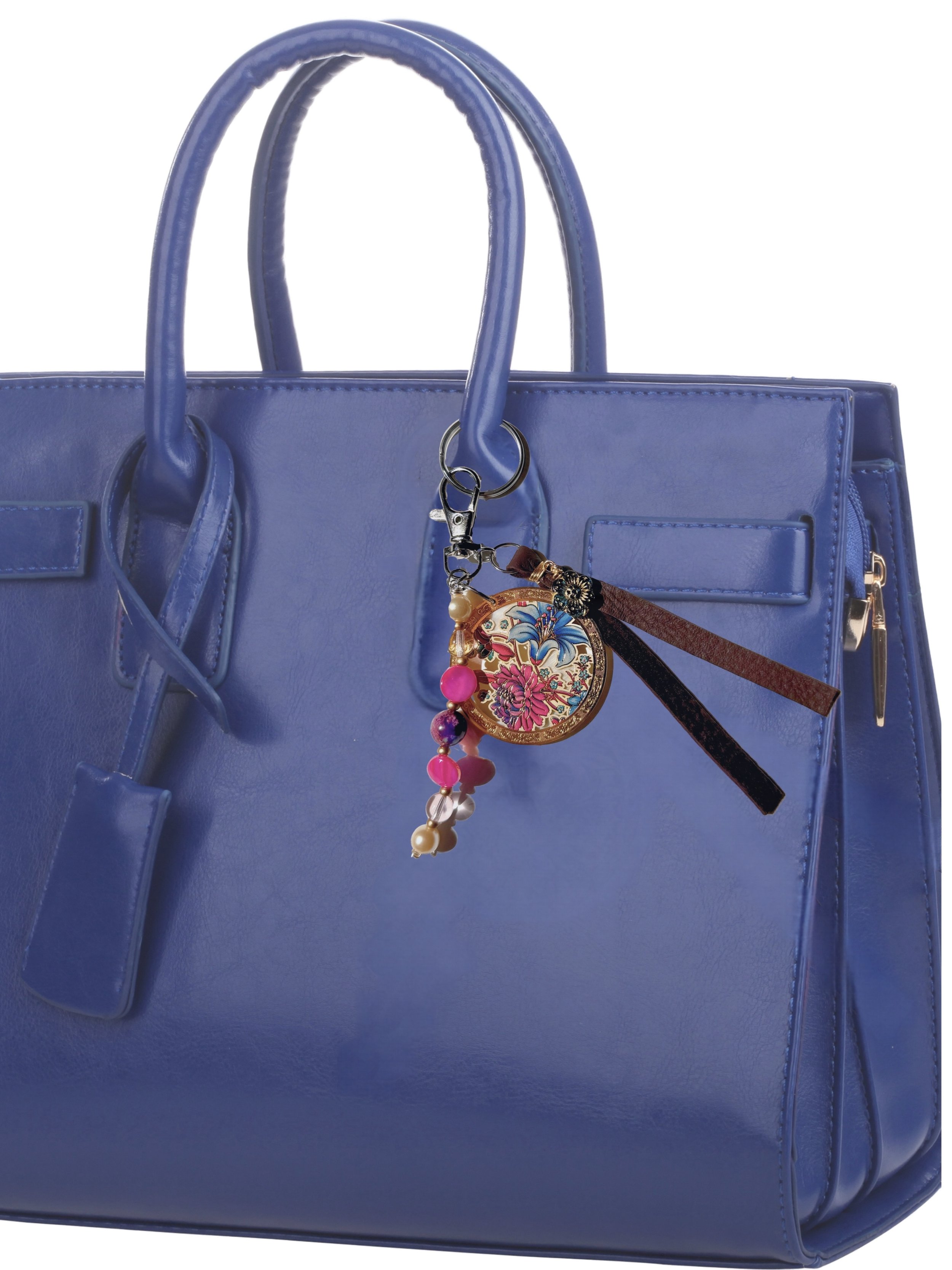 Floral gold finish medallion, mother of pearl, beads and leather tassel bag charm on blue handbag
