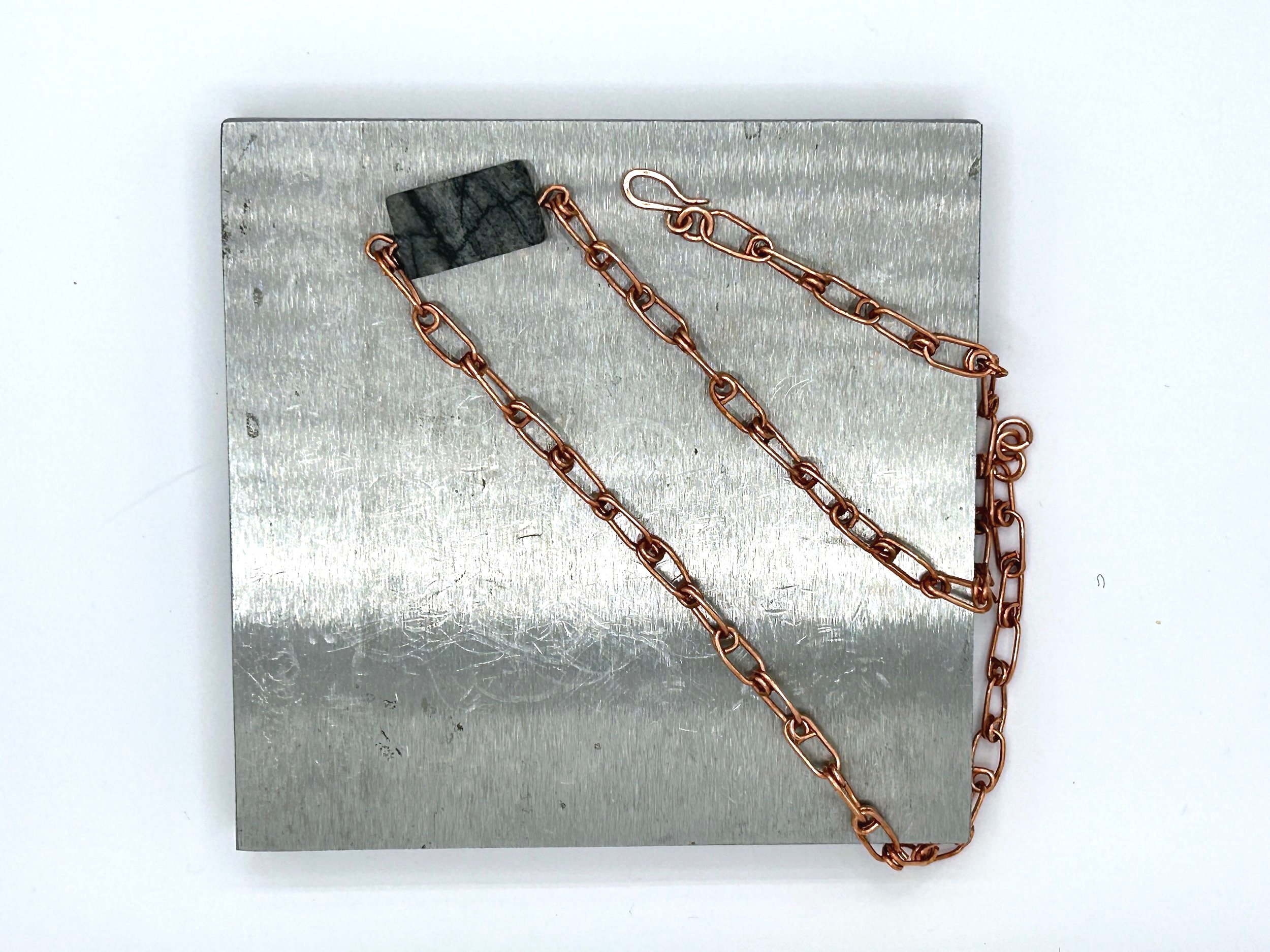 Gray Jungle Jasper Rectangle stone with Copper Link Chain Ellis Necklace on metal block