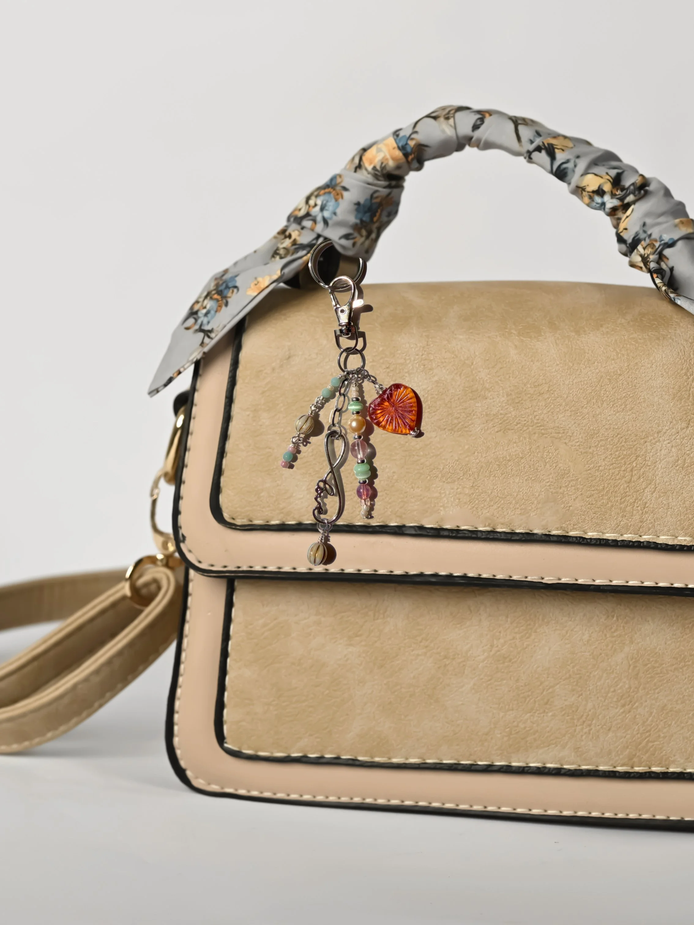 Radiant Heart Bag Charm with pink Czech Glass heart and pastel beads on tan handbag