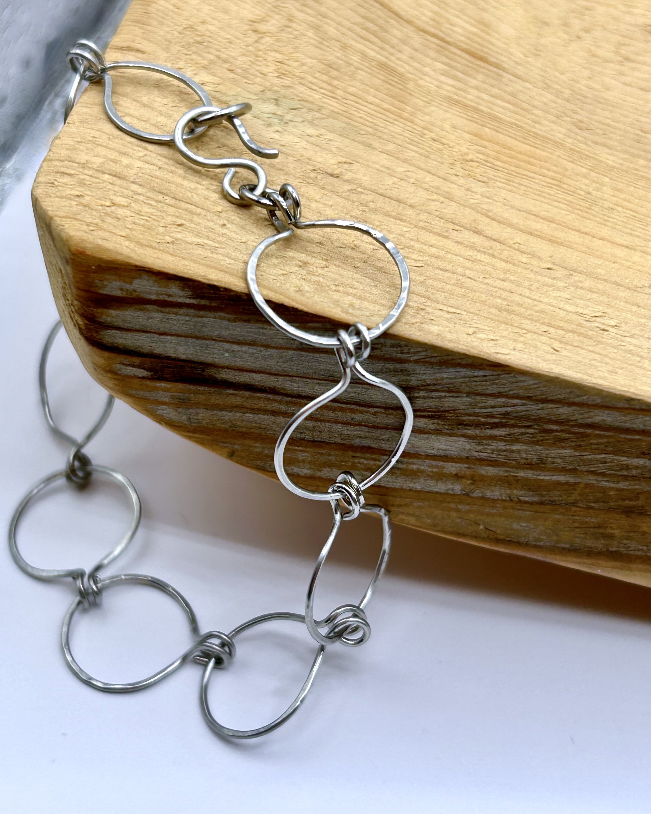 Caroline Open Circles Bracelet in Sterling Silver-filled draped on Wood