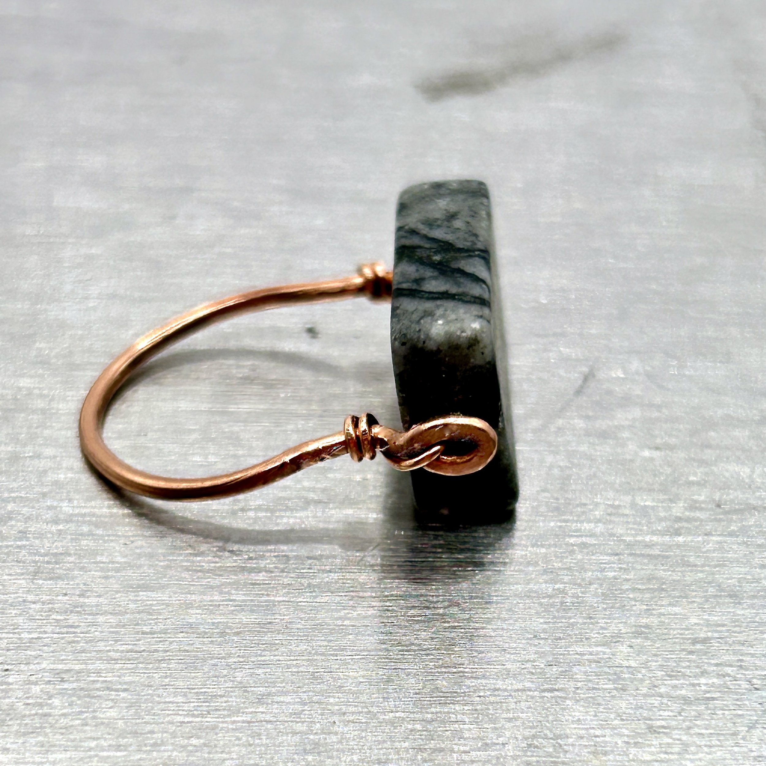 Gray Jungle Jasper rectangle stone on Copper Metal Ring on metal block side view