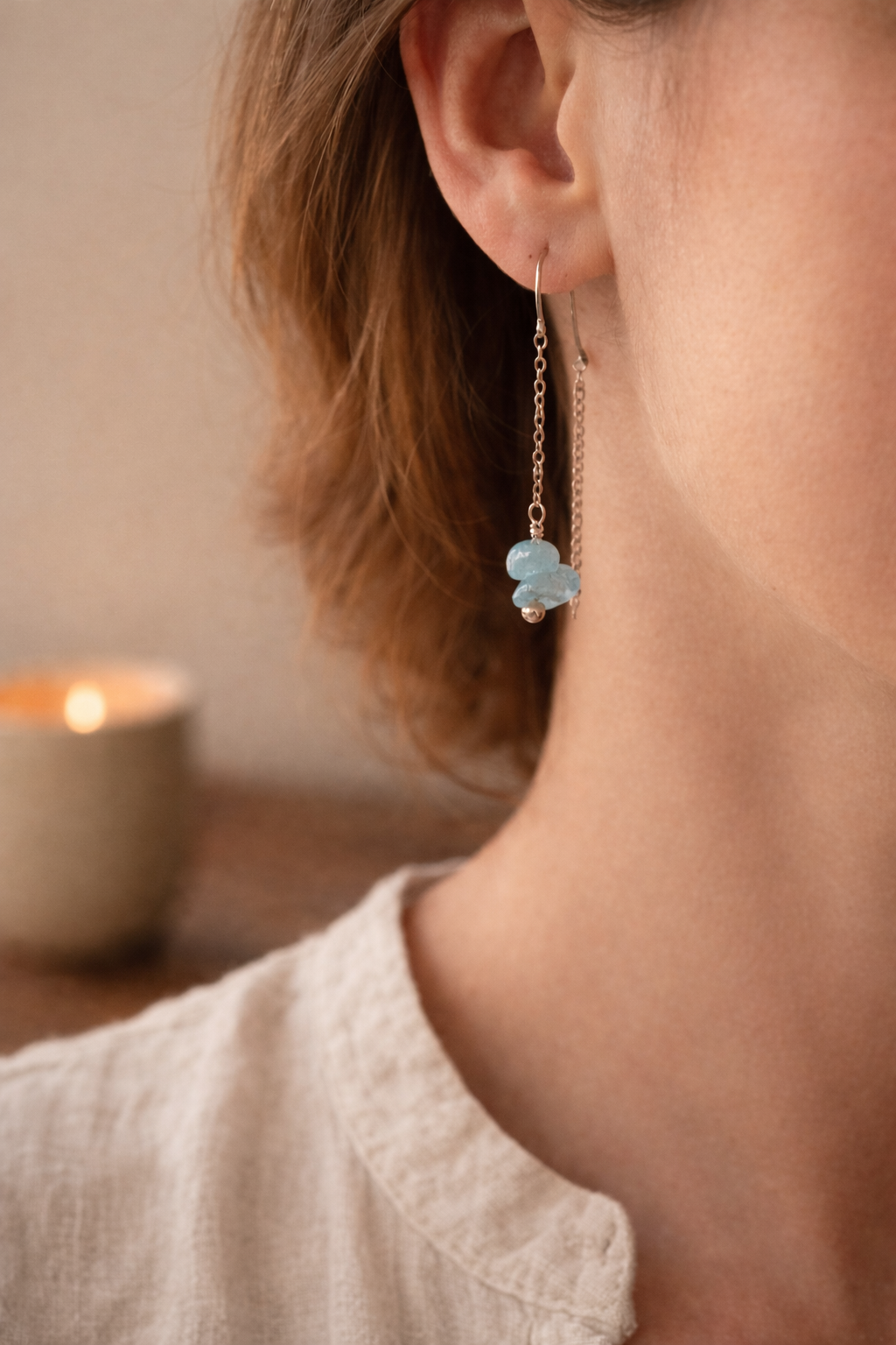 Woman wearing aquamarine dangle earrings