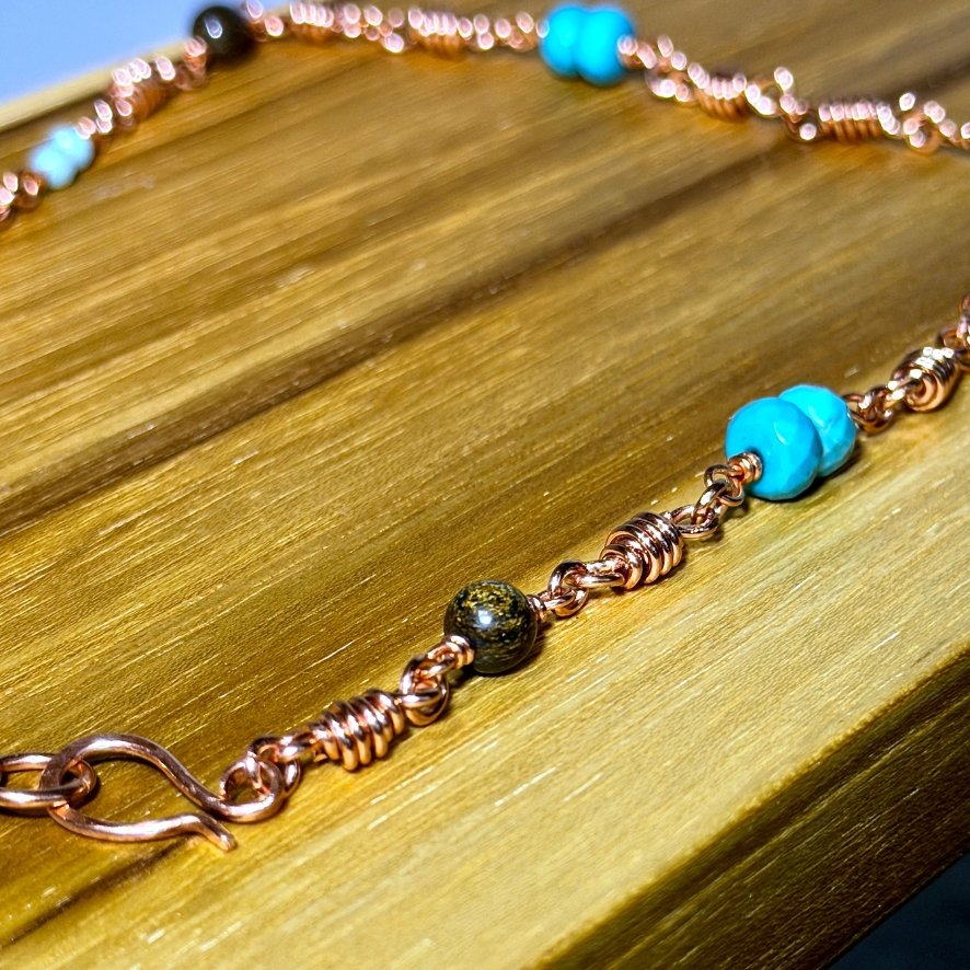 West Texas Sunset Copper and Beaded Necklace close up on wood