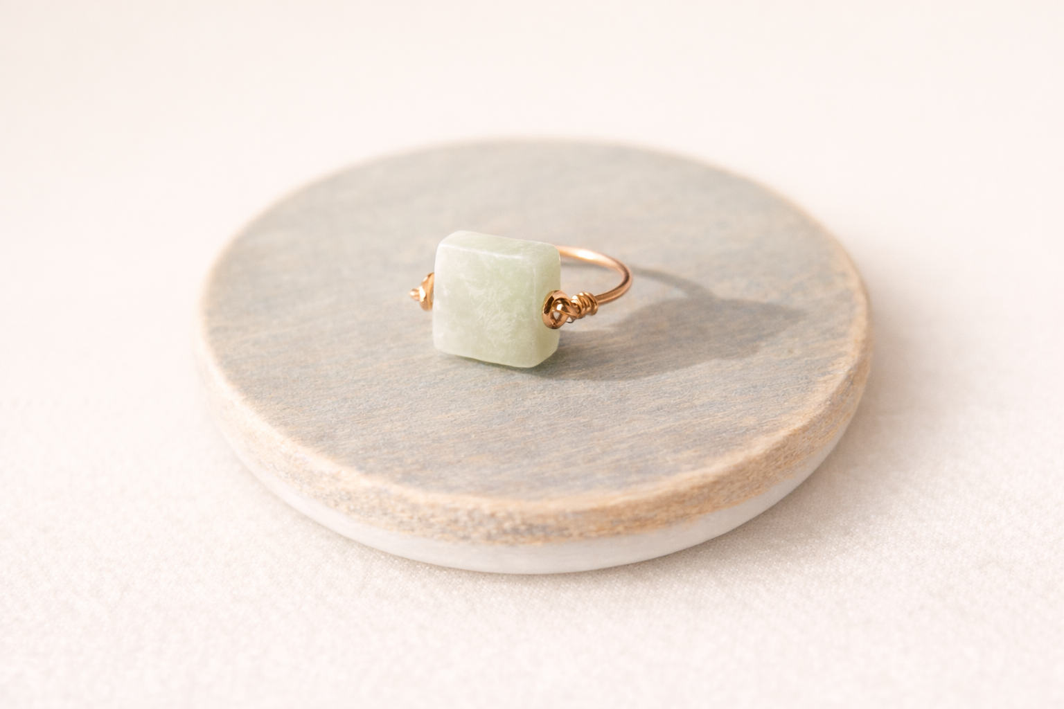 Amazonite ring on light wood background