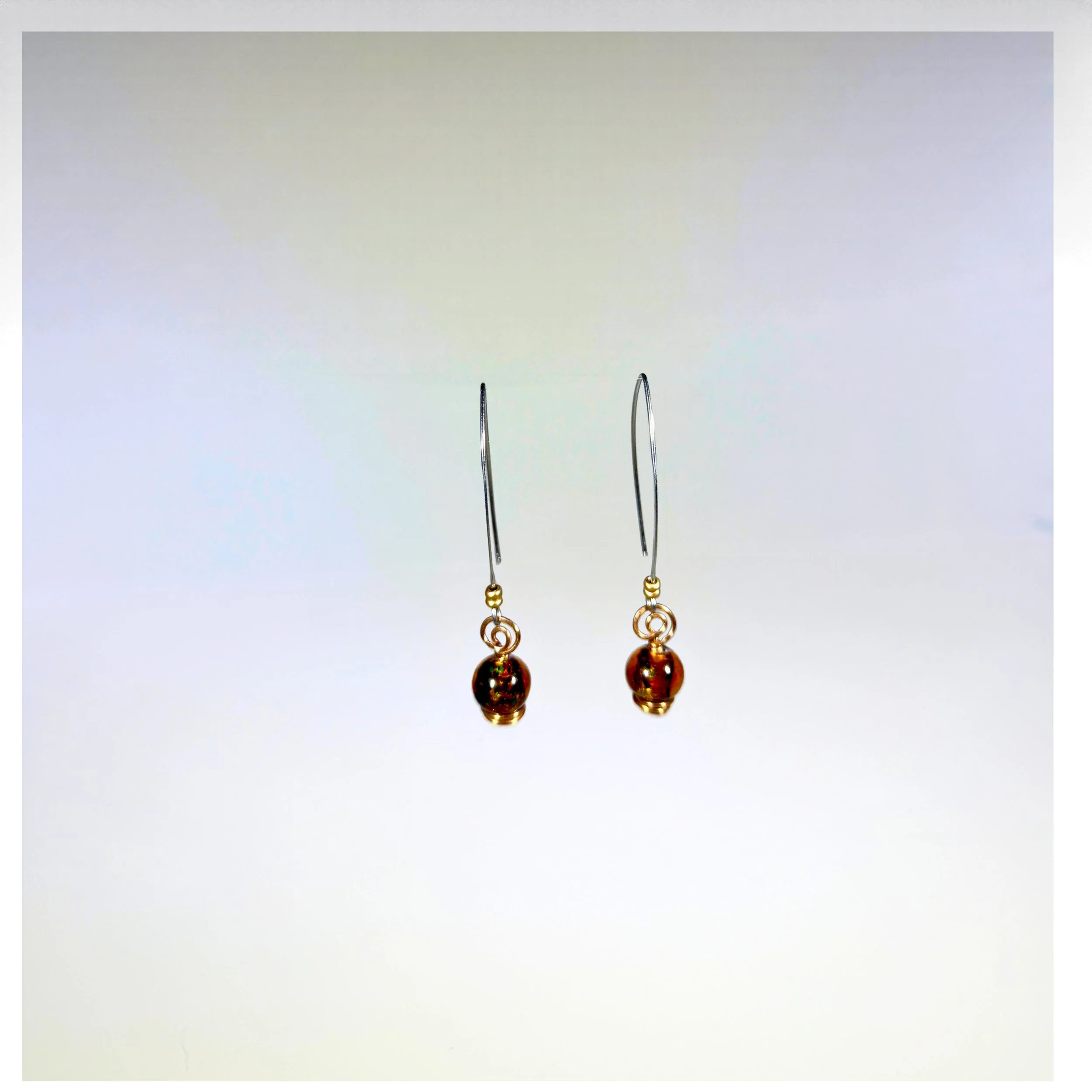 Copper Sol Amber Earrings on light background