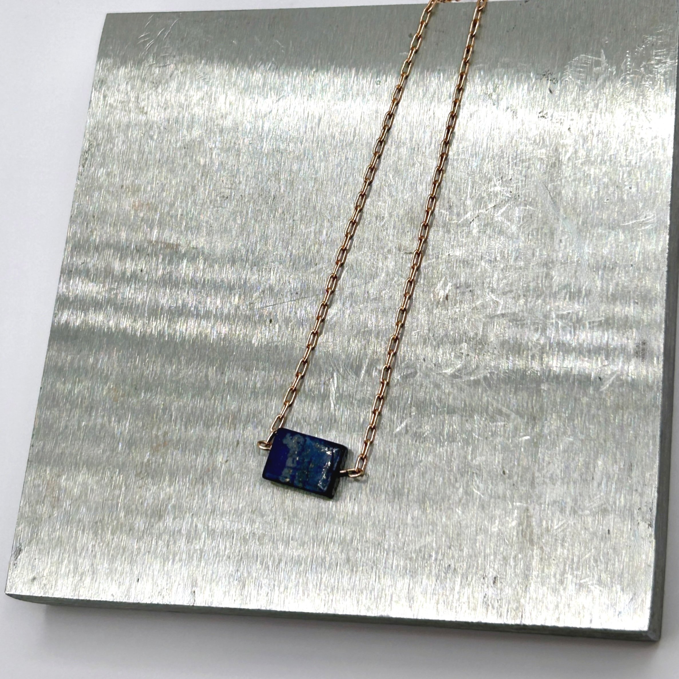Pedra Lapis Lazuli rectangle stone on petite Rose Gold Plated Necklace on metal block