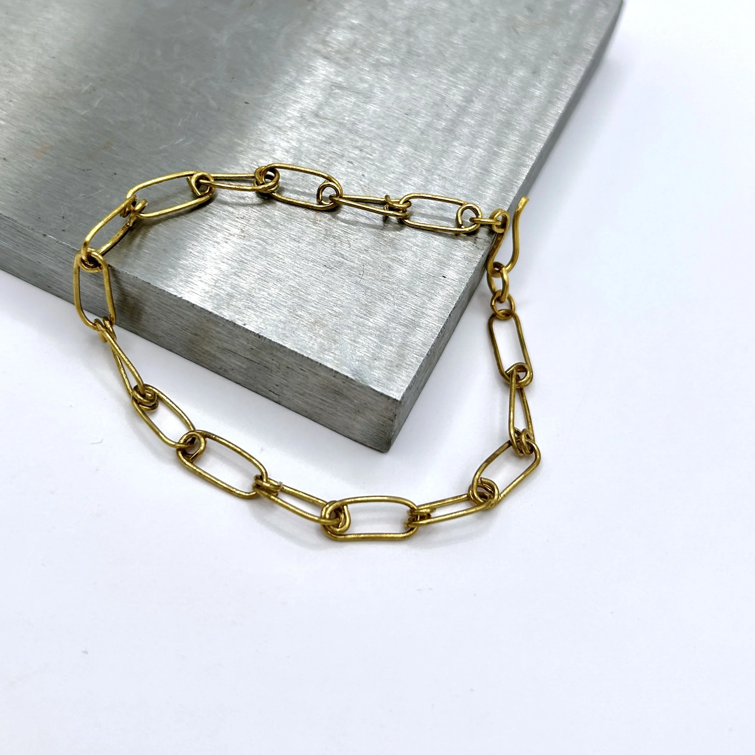 Ellis Jeweler's Brass Metal Safety Pin Link Bracelet on metal block