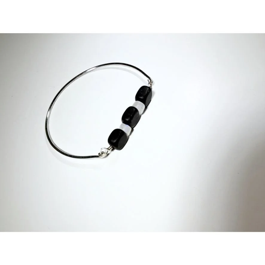 Blackstone and Rainbow Moonstone Silver Bangle on a neutral background.