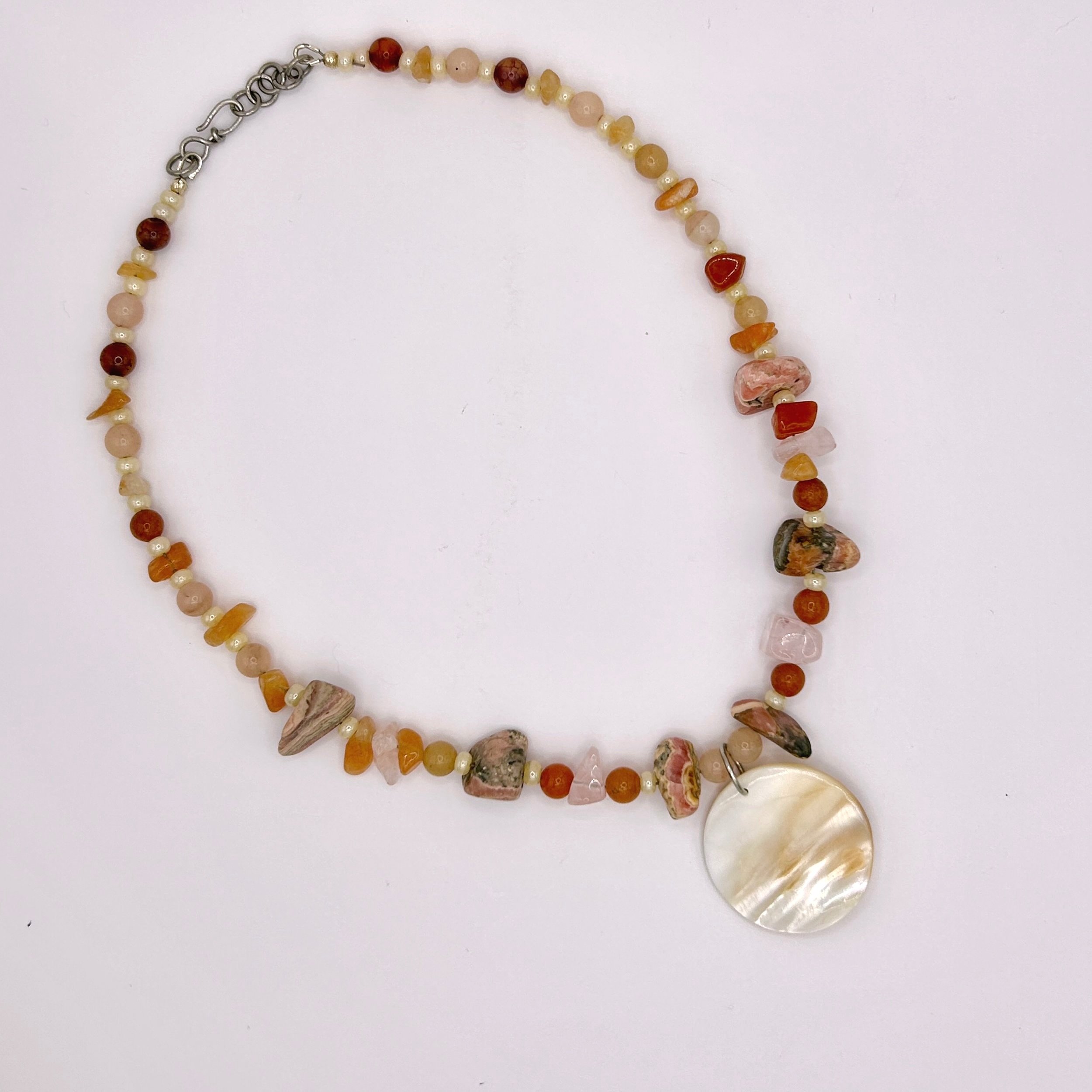 Barranca Mother of Pearl, Rhodochrosite, and beaded necklace on white background