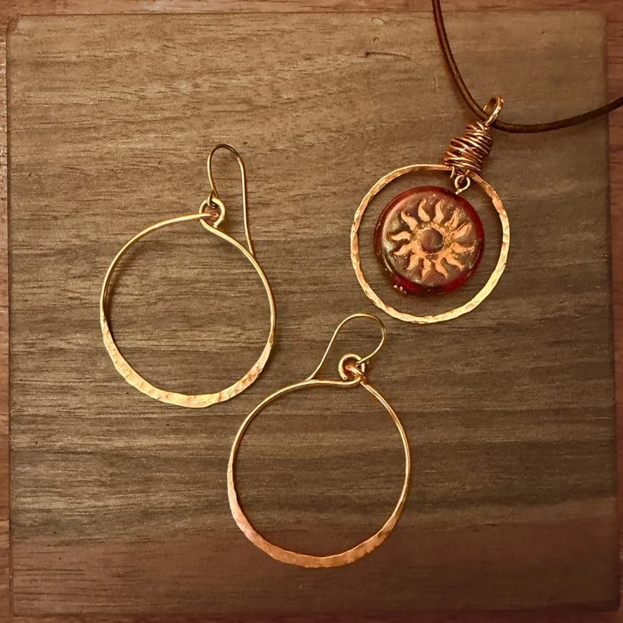 Copper Sol Circle Necklace with Czech glass and Hand Formed Copper Circle on Adjustable Leather Necklace and Hand Formed and Textured Copper Earrings on wood