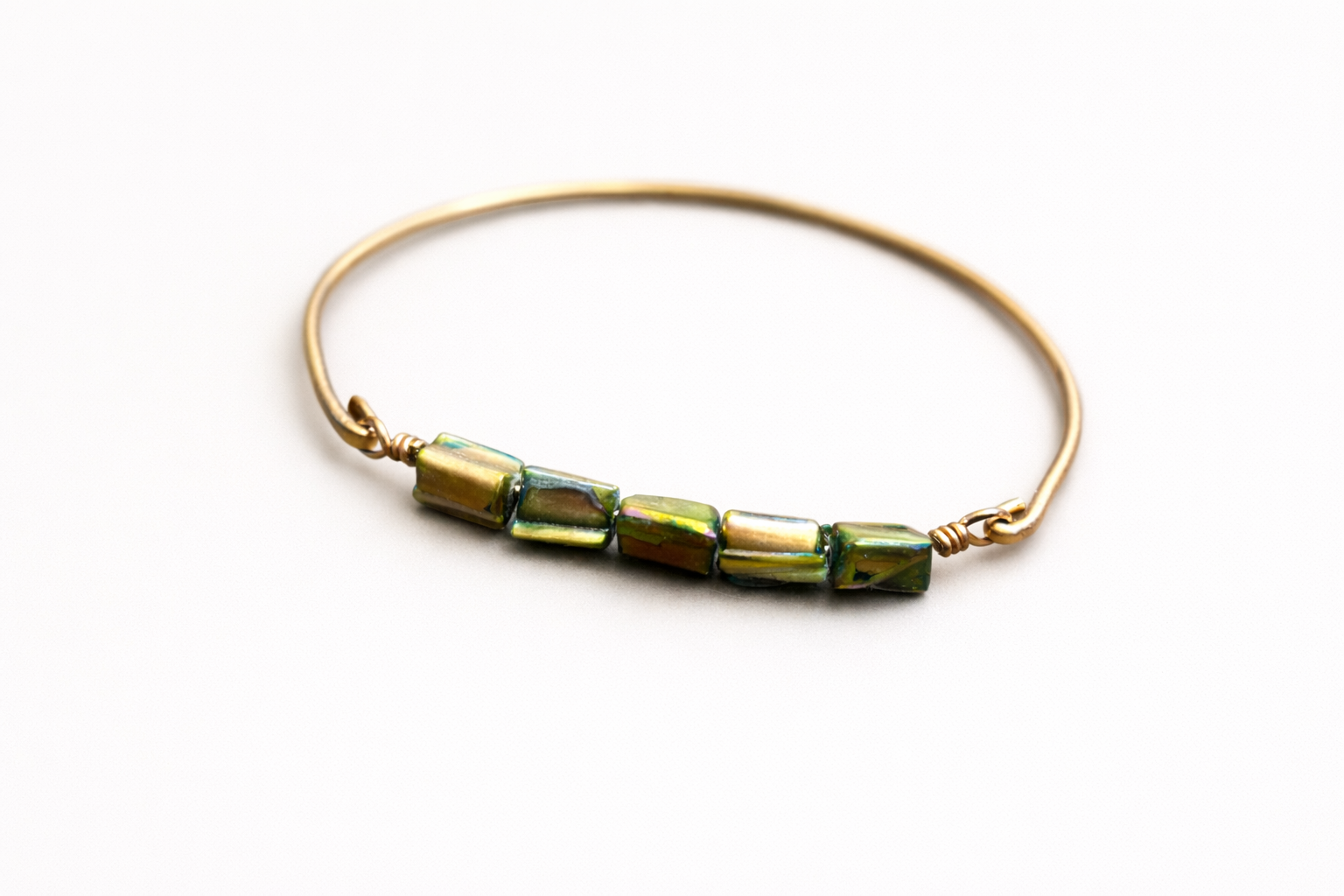 Golden Pine Mother of Pearl Brass Bangle Bracelet on light background