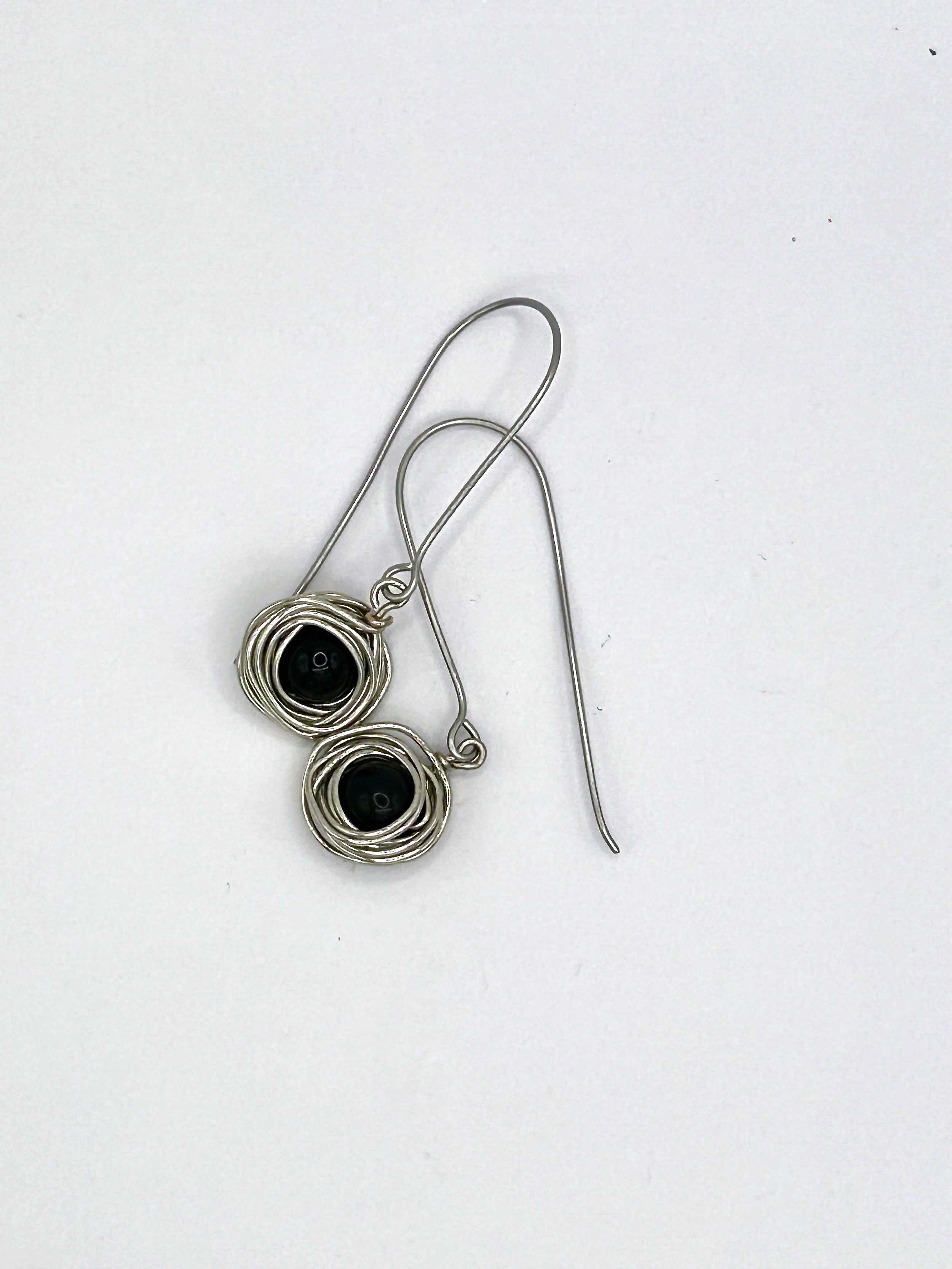 Messy Bun Earring with Black Bead nested in Stainless Steel metal and stainless steel long drop ear wires on white background