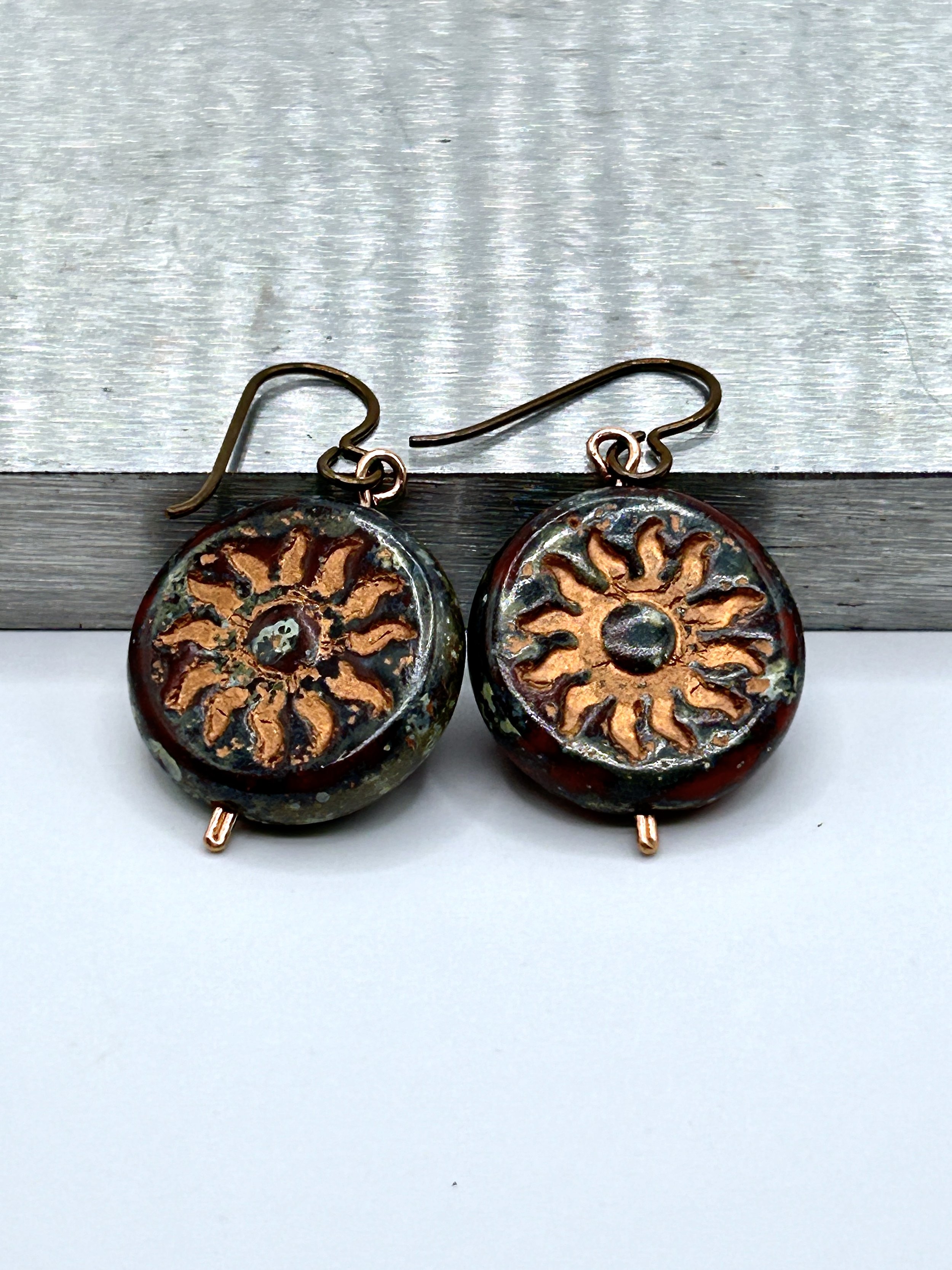 Winter Sol Deep Burgundy and Copper Starburst Czech Glass Coin short drop earrings with copper metal french ear wires on metal block