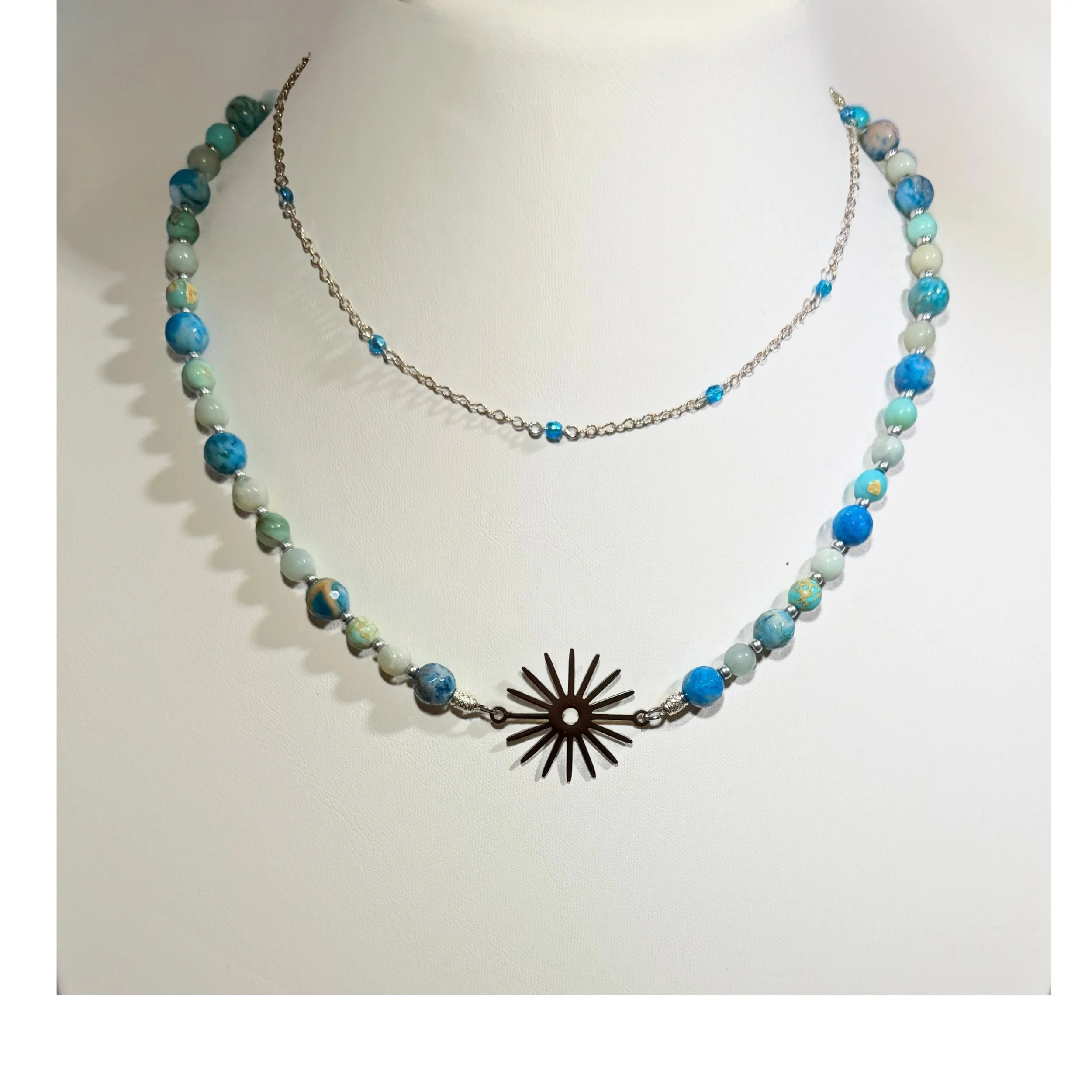 Blue Gemstone Starburst Necklace layered with blue crystal necklace
