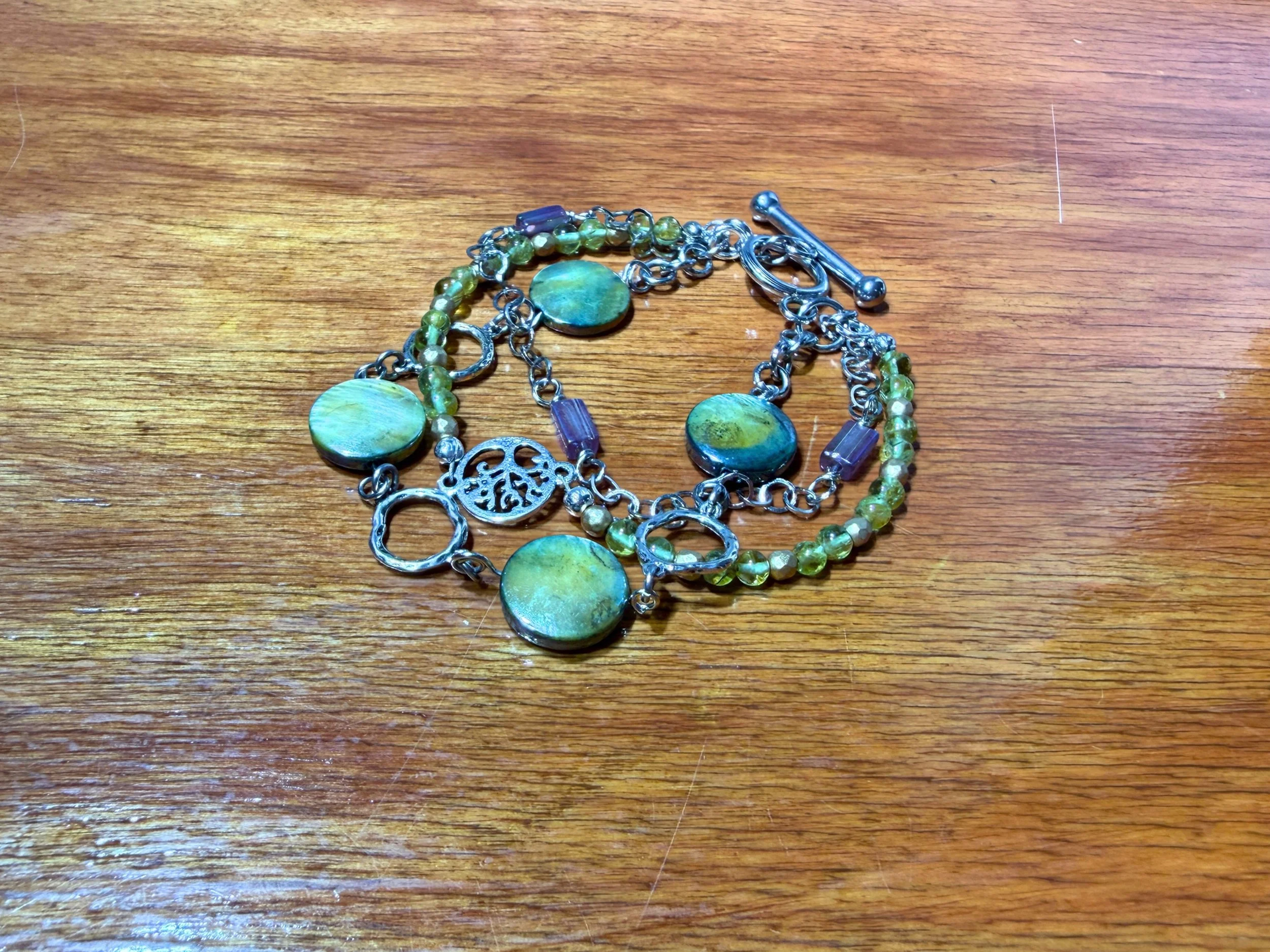 Olive Mother of Pearl Multi Strand Bracelet on wood