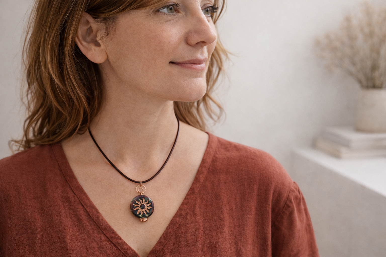 copper sunburst necklace on person.png