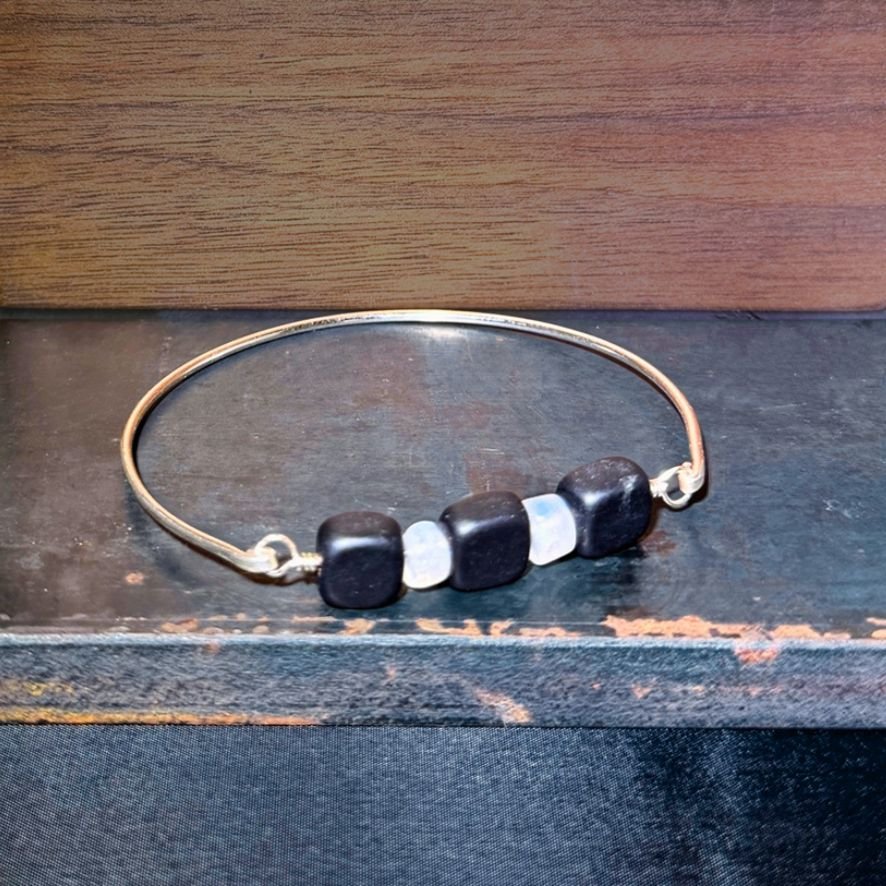 Blackstone and Rainbow Moonstone Silver Bangle on metal
