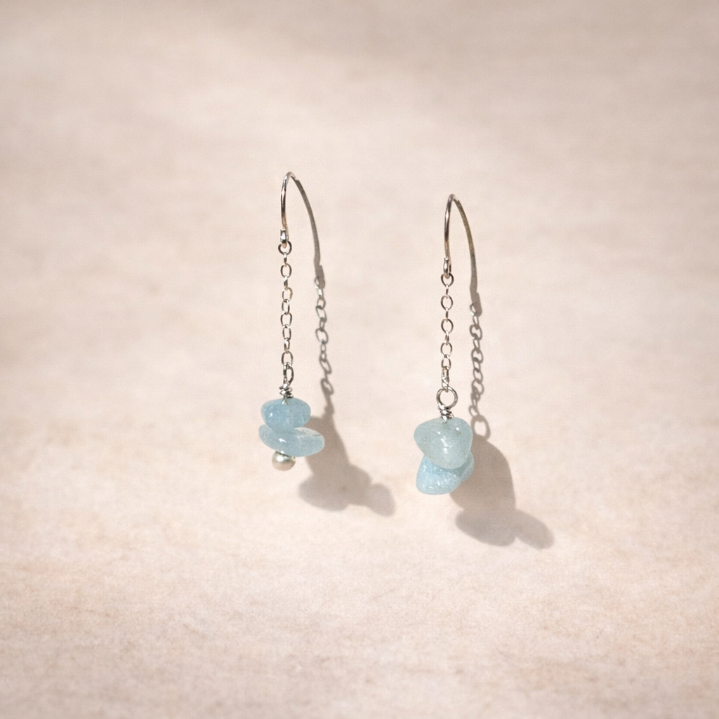 Aquamarine on delicate silver chain dangle earrings on pink background