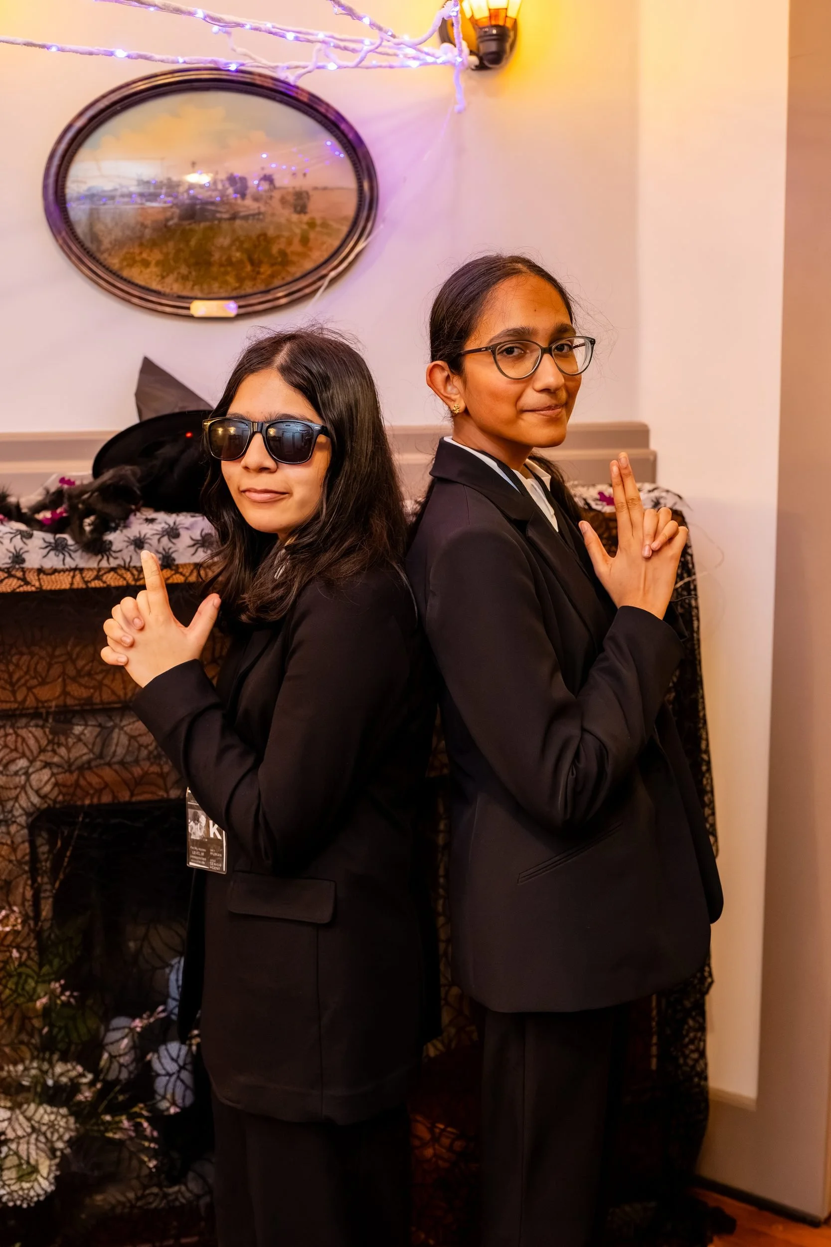 Two students in black suits and sunglasses at the reception