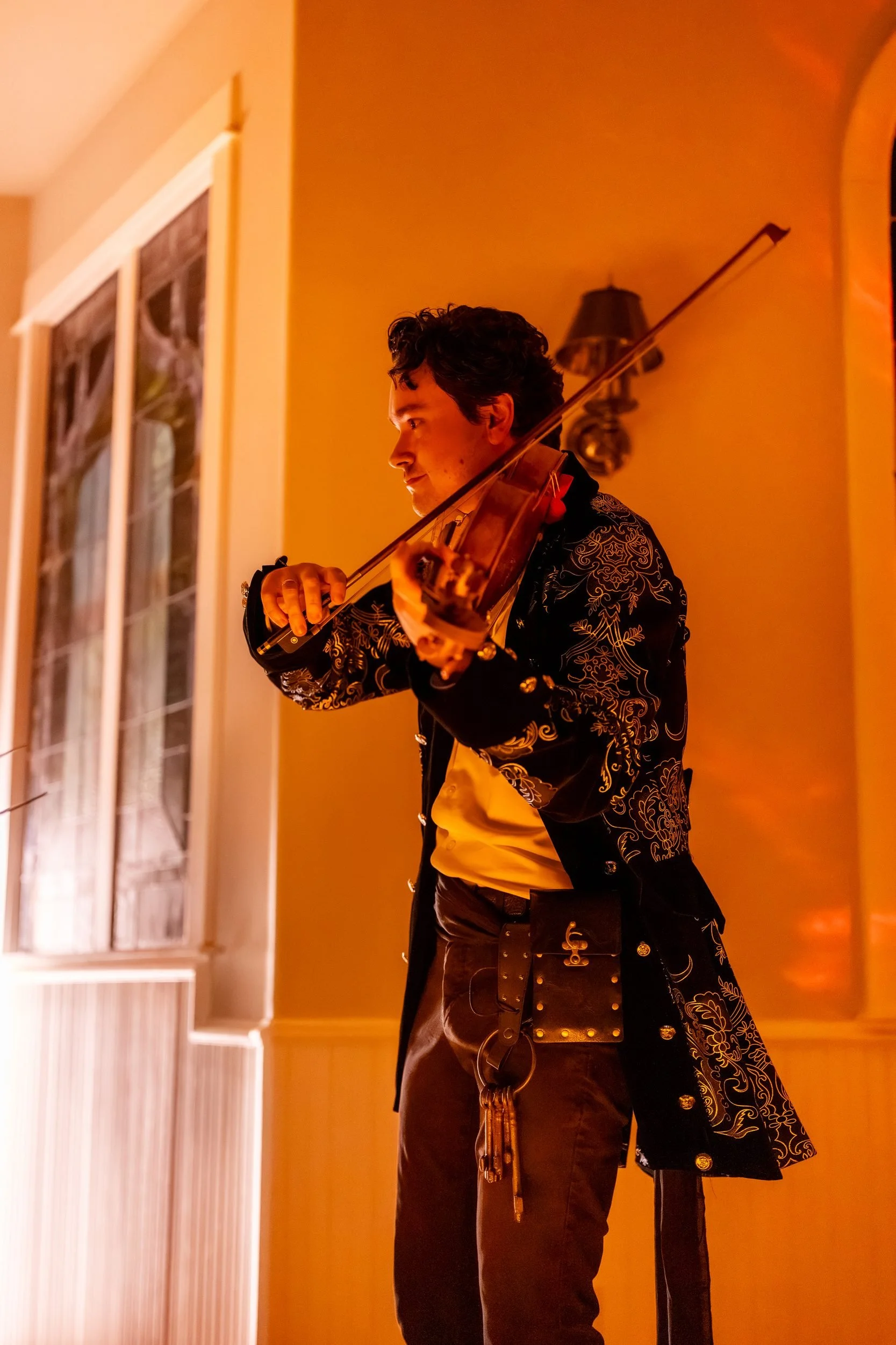 String player in full pirate costume standing by the window