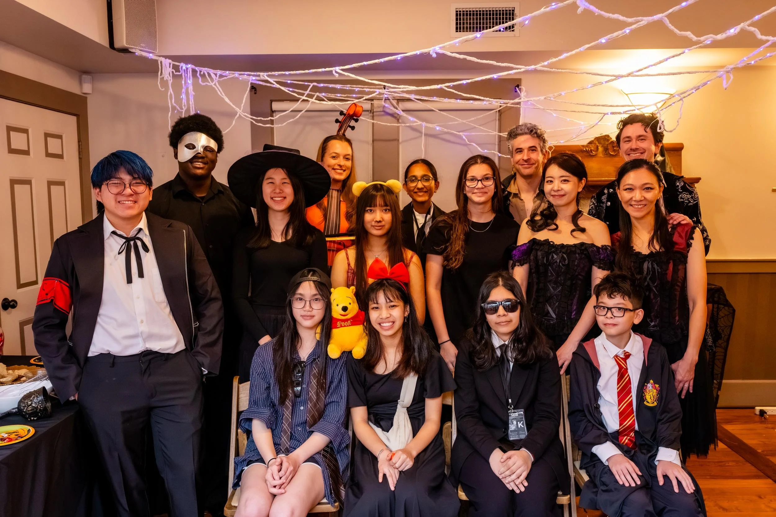 Students and musicians in costume gathered for a group photo at the reception