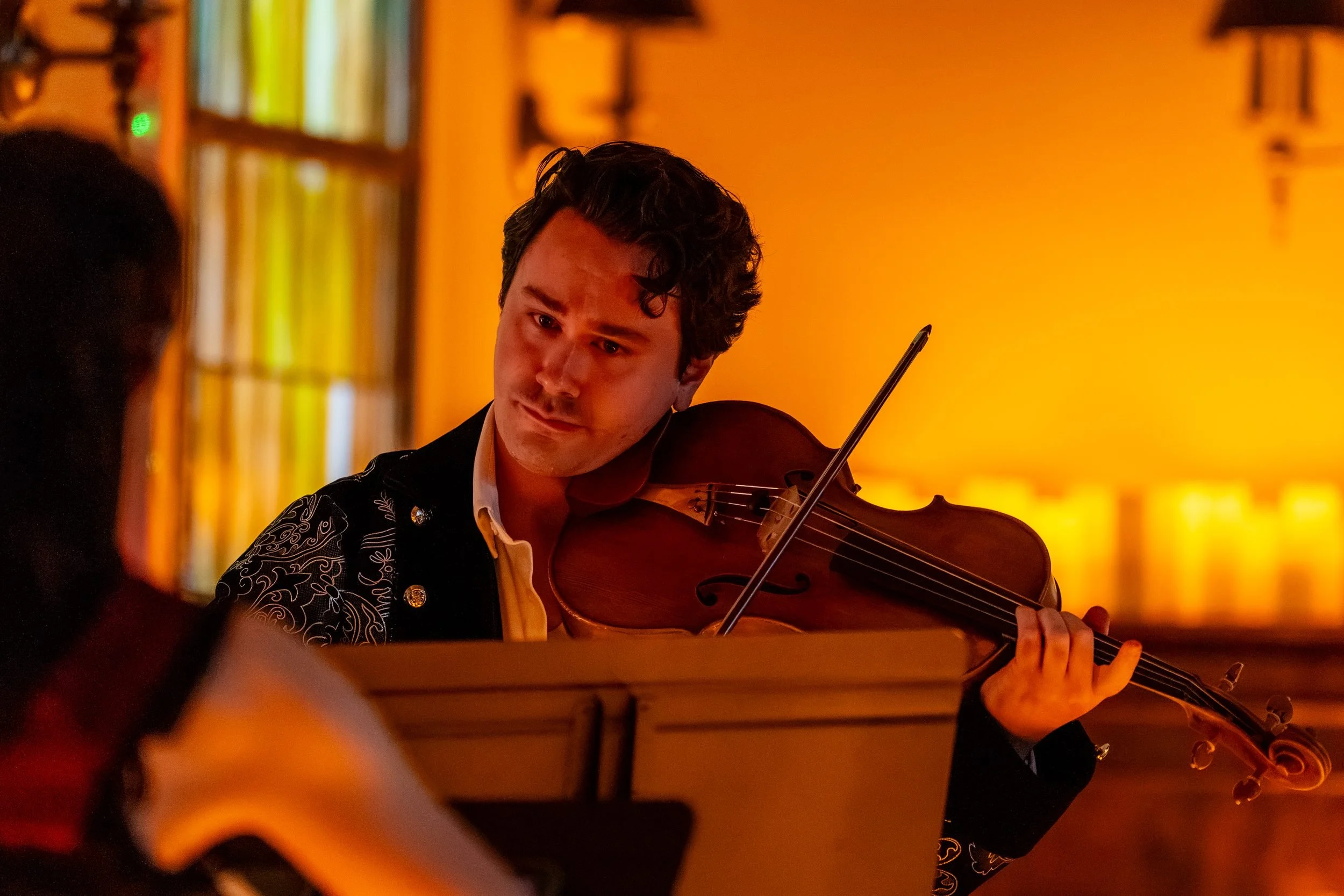 String player performing by candlelight