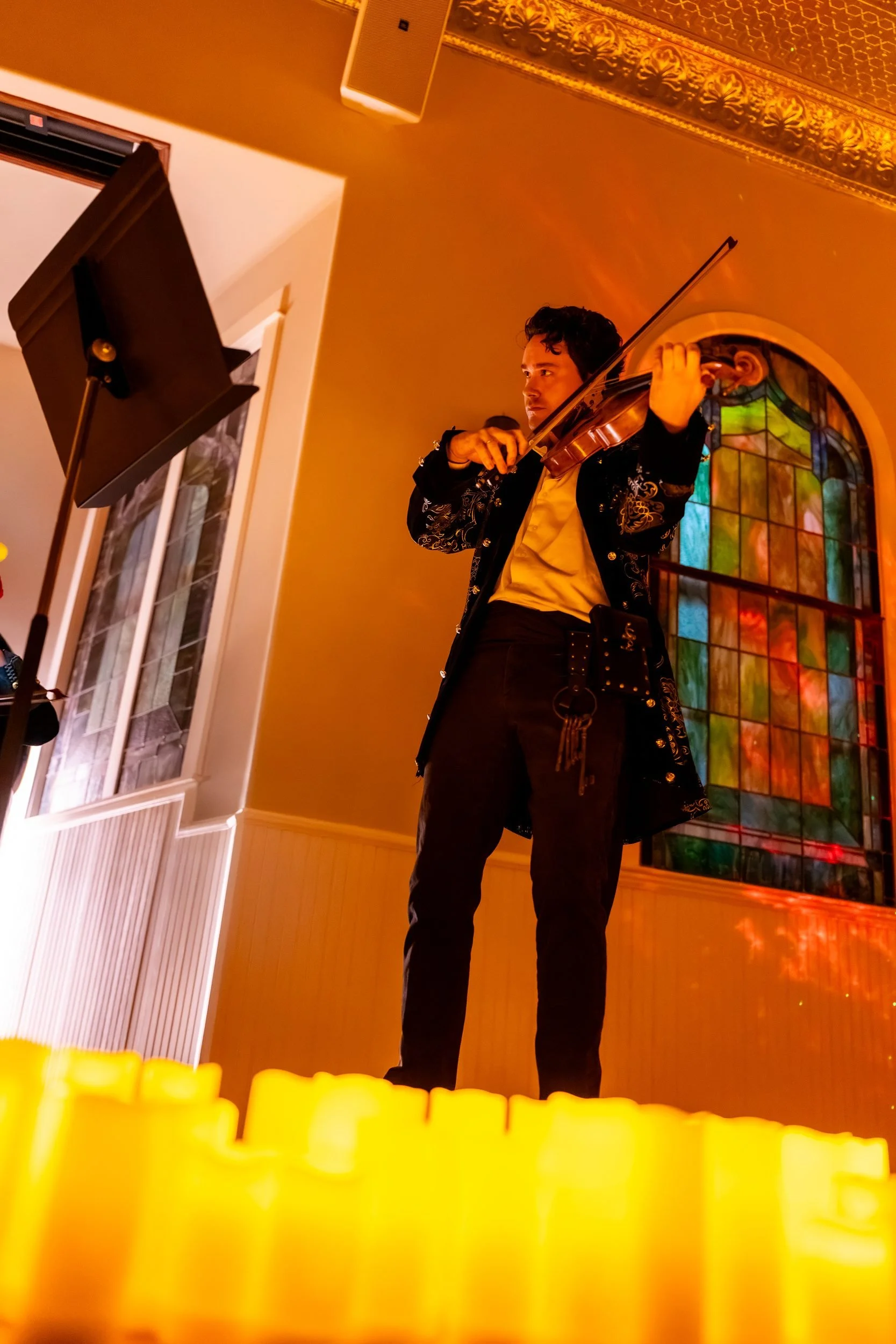 String player performing above a row of candles